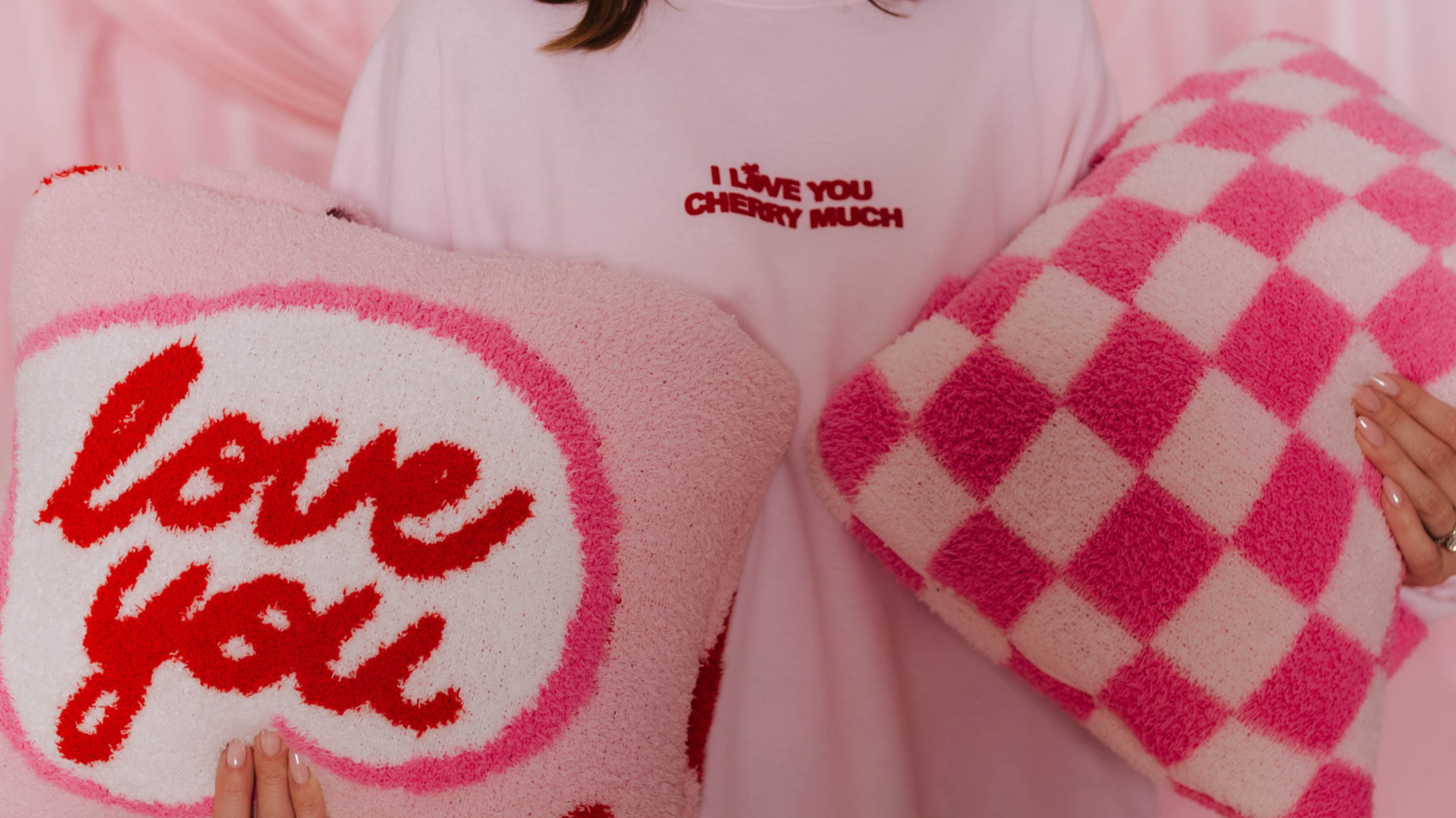 Krista holding two quillows - love you and pink check