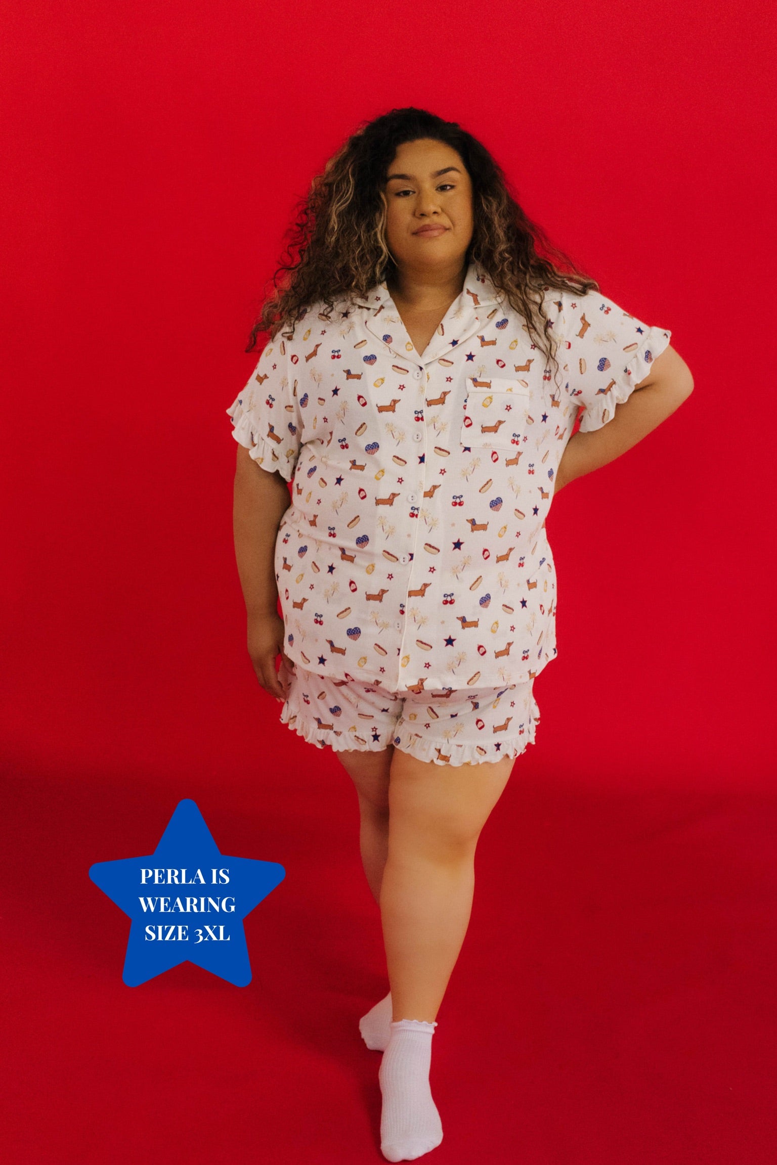Woman wearing a patterned pajama set on a red background