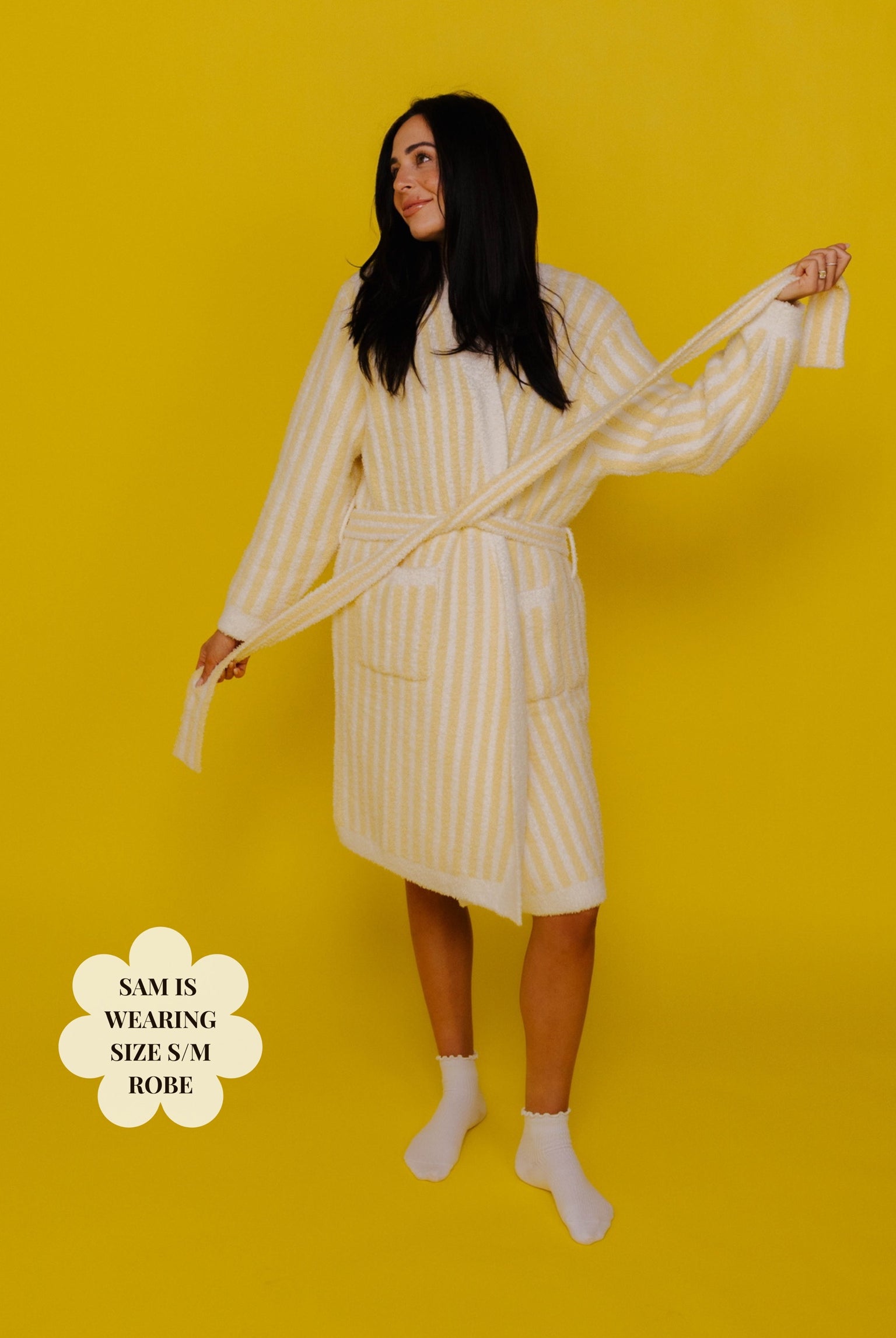 Woman wearing a yellow striped robe against a yellow background size M