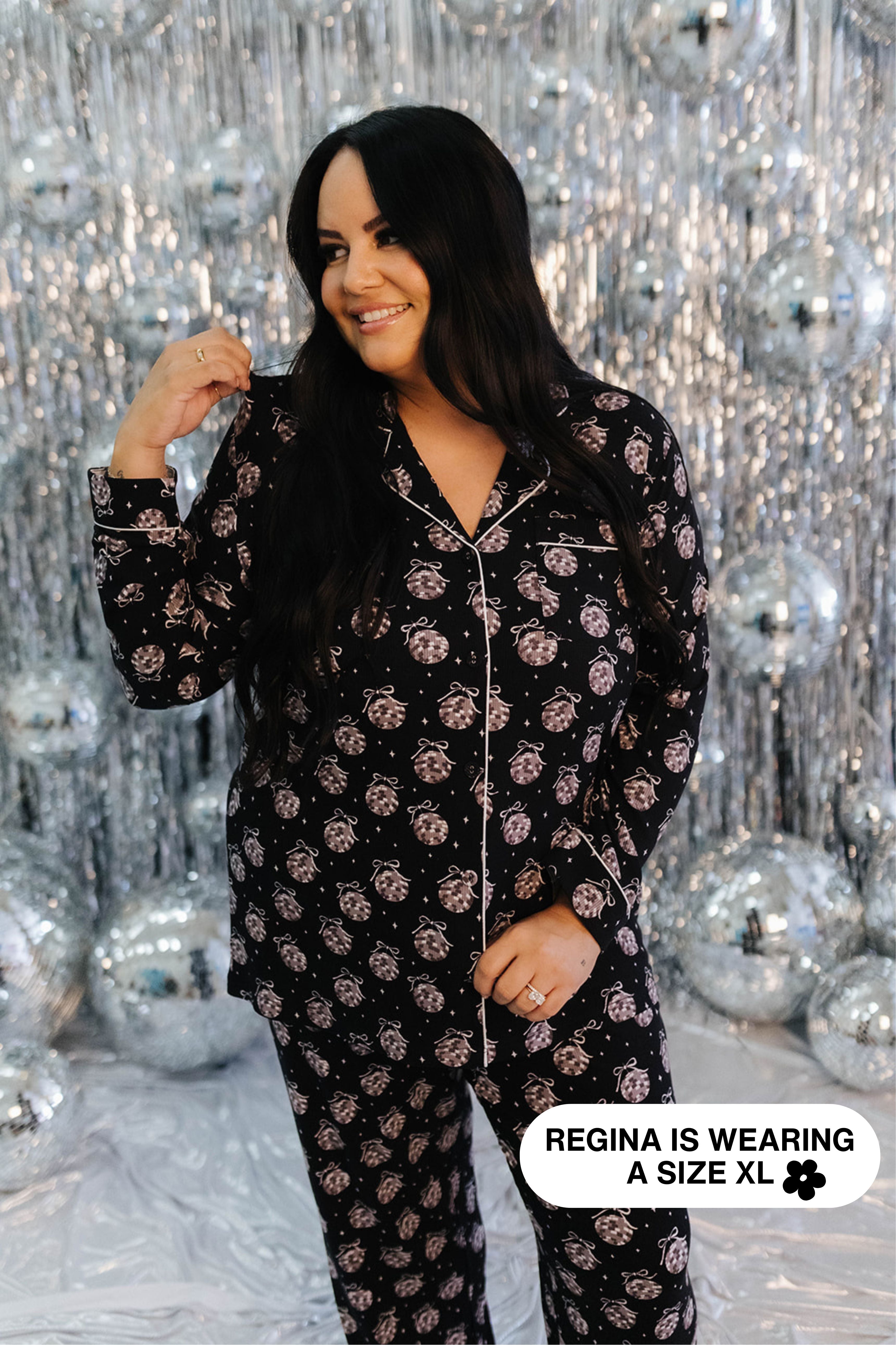 Woman wearing a black disco ball pajama set against a silver disco ball background
