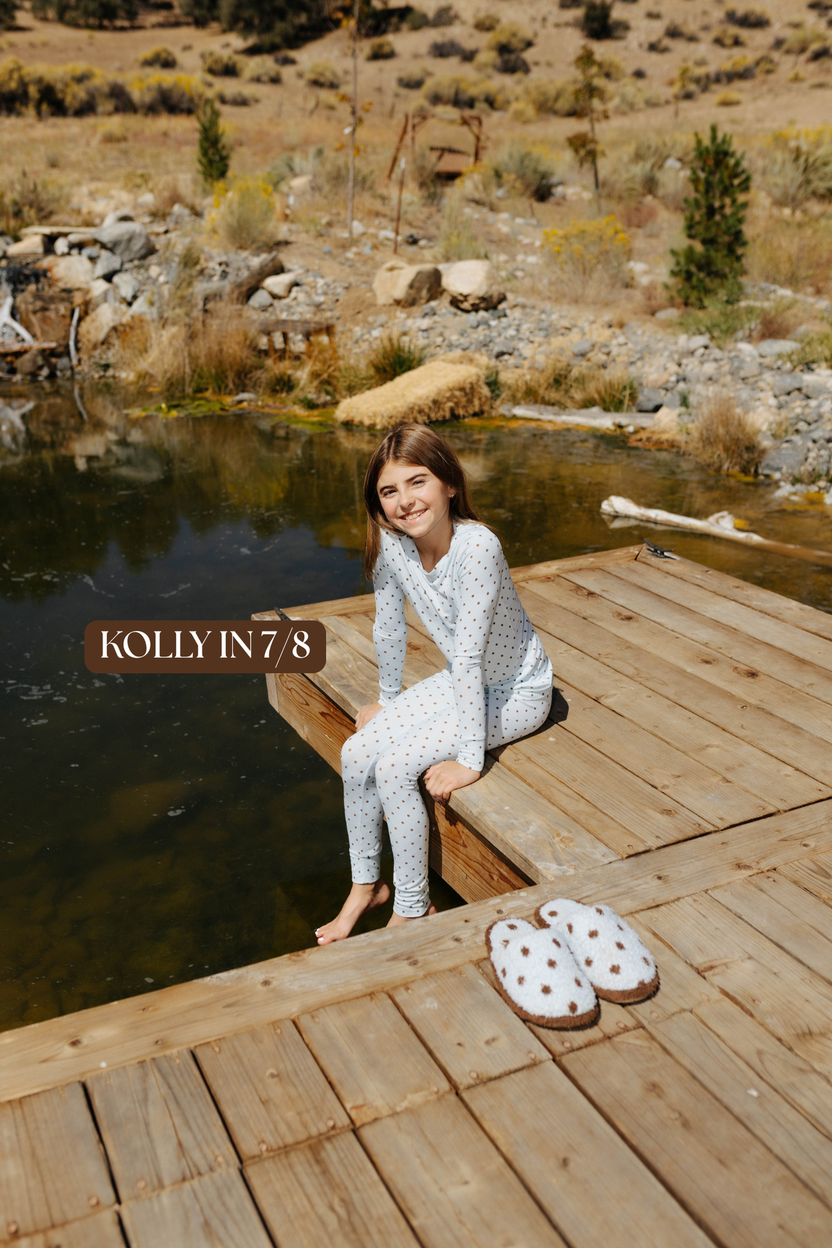 Sizing photo: Kolly in 7/8 wearing blue with brown polka dots kids pajama set.