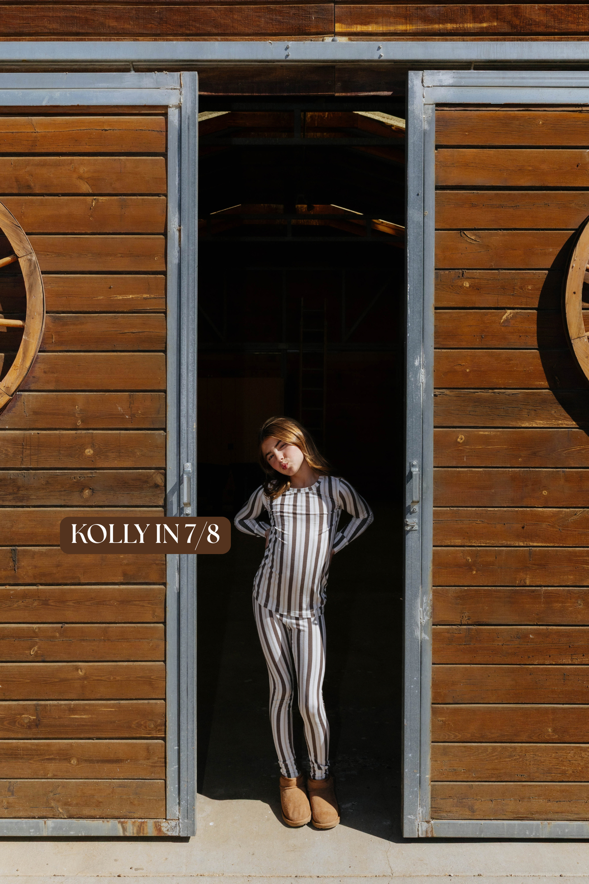 Sizing photo: Kolly in 7/8 wearing brown and cream striped kids pajama set.