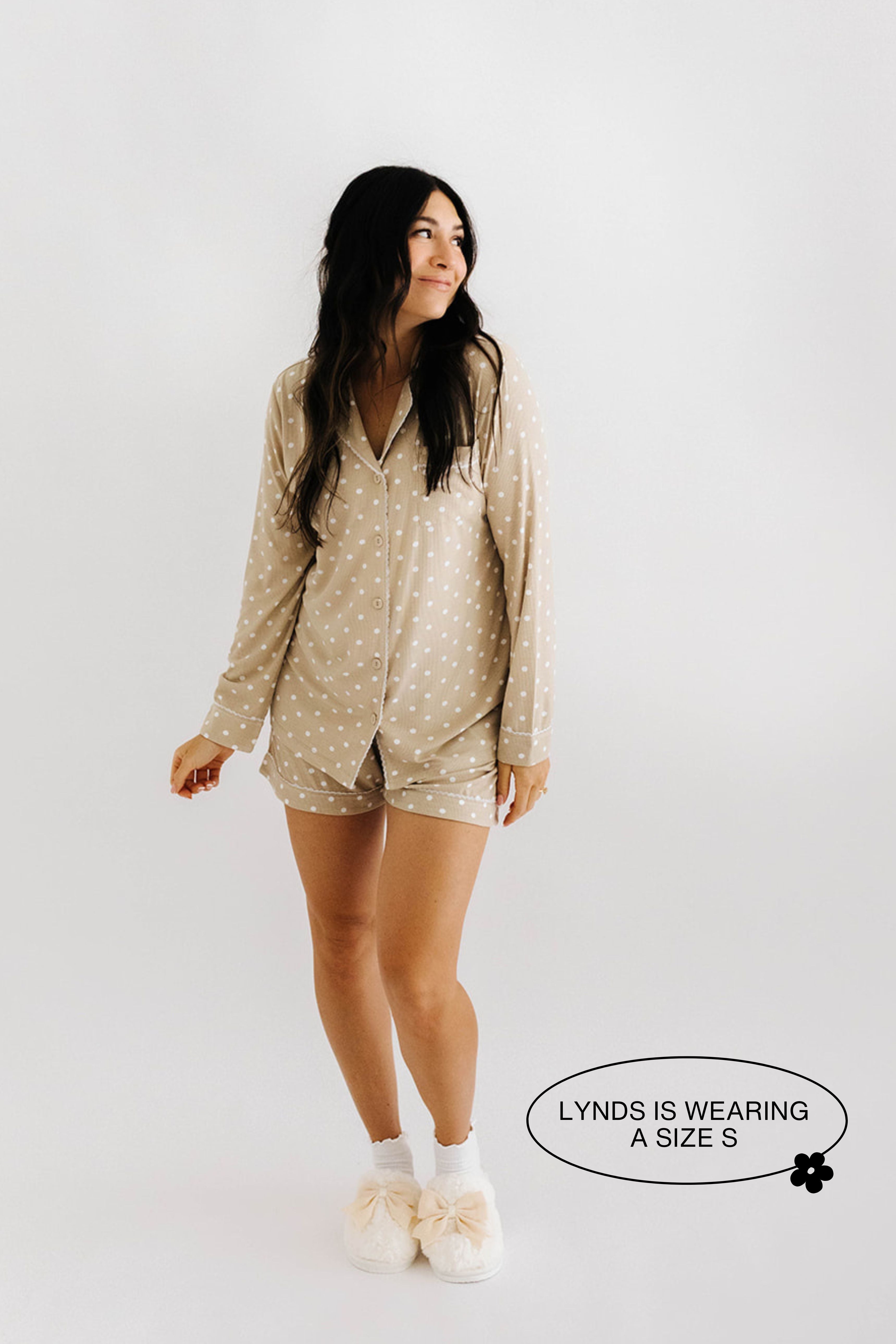model lynds smiling wearing size small in lace polka dot pajamas