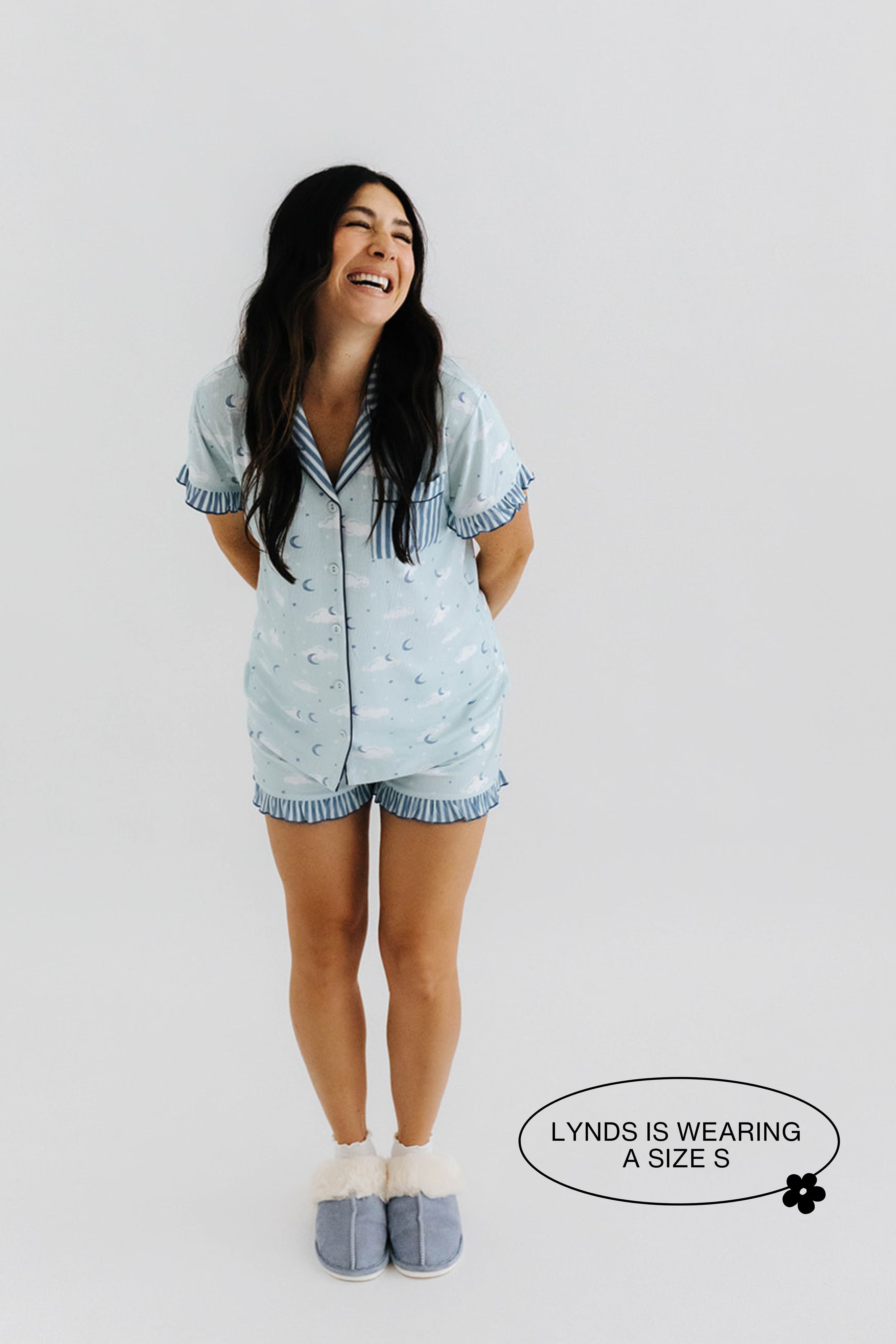 model lyndsee smiling wearing the cloud ruffle pajamas in size small