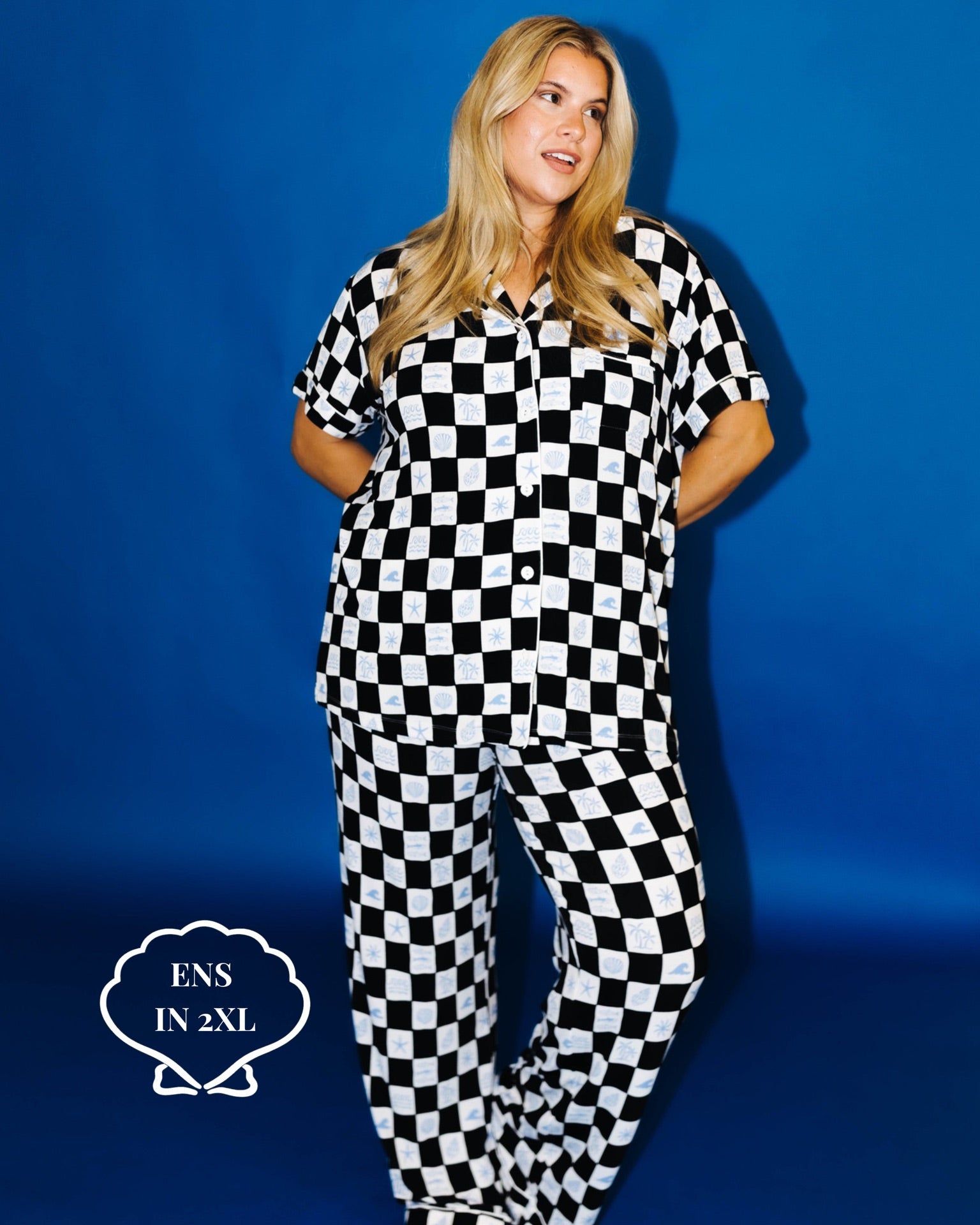 Person wearing a black and white checkered outfit against a blue background