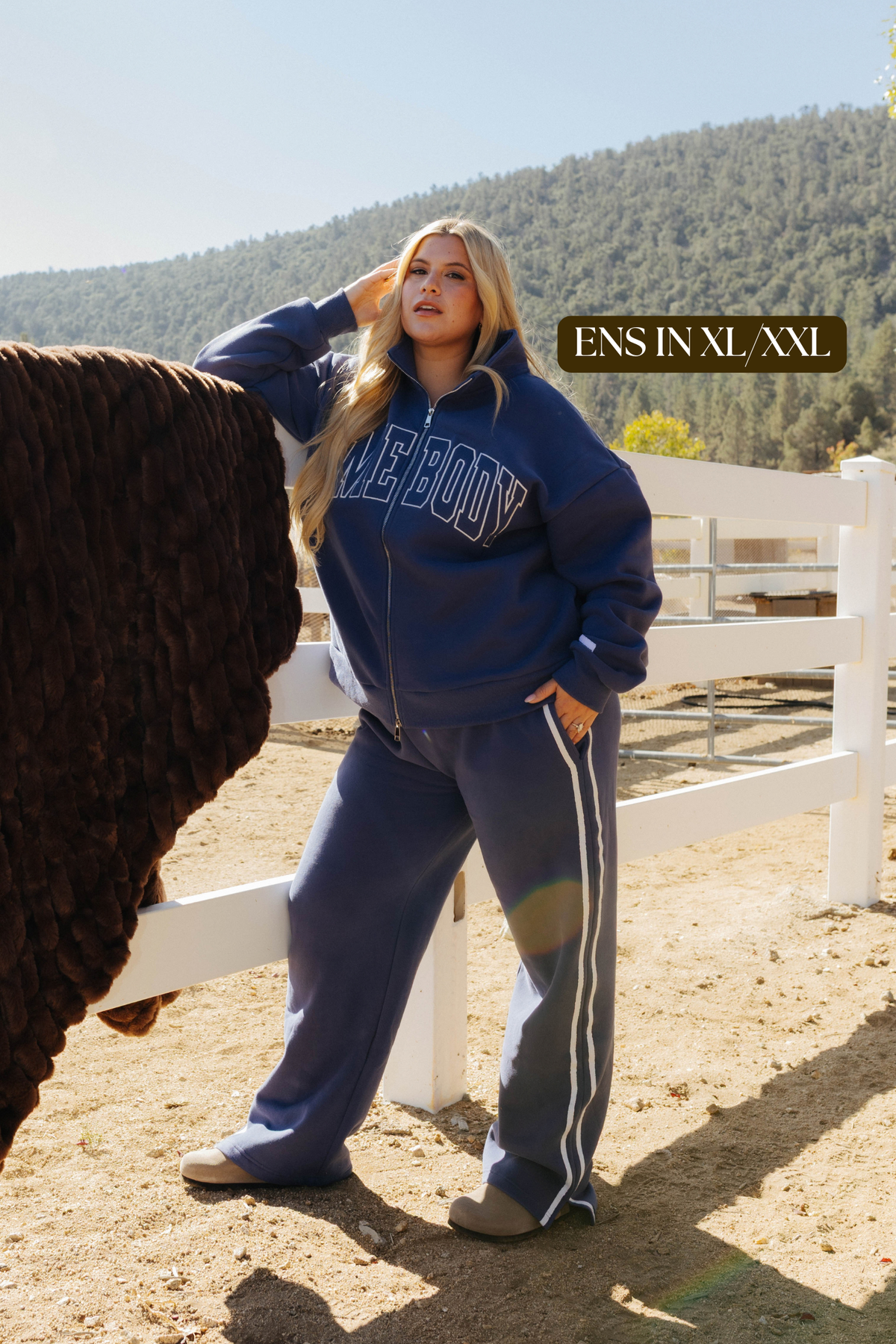Sizing photo: Ens in XL/XXL wearing blue Homebody sweatshirt and sweatpants.
