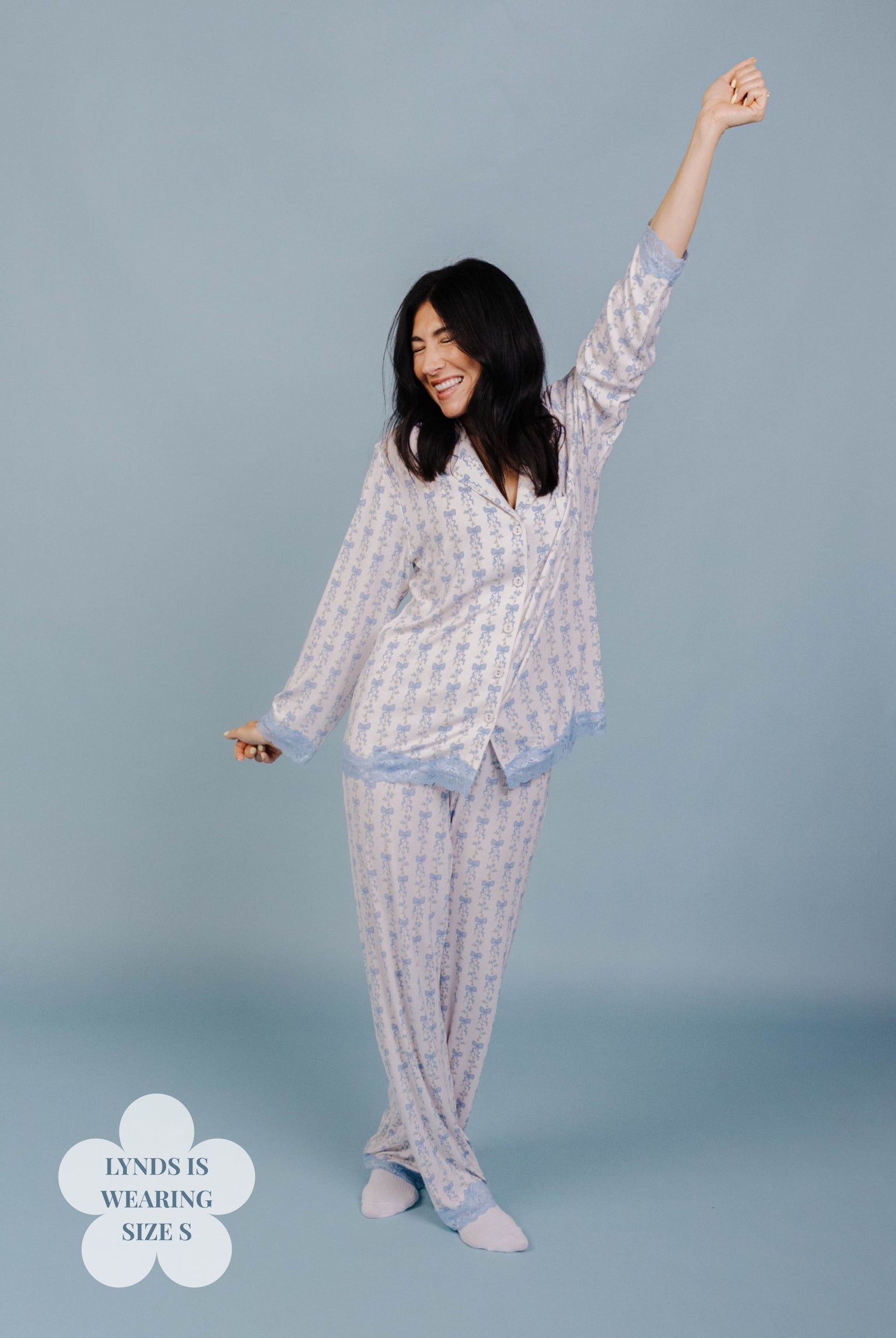 Woman wearing a size S pj on a blue background