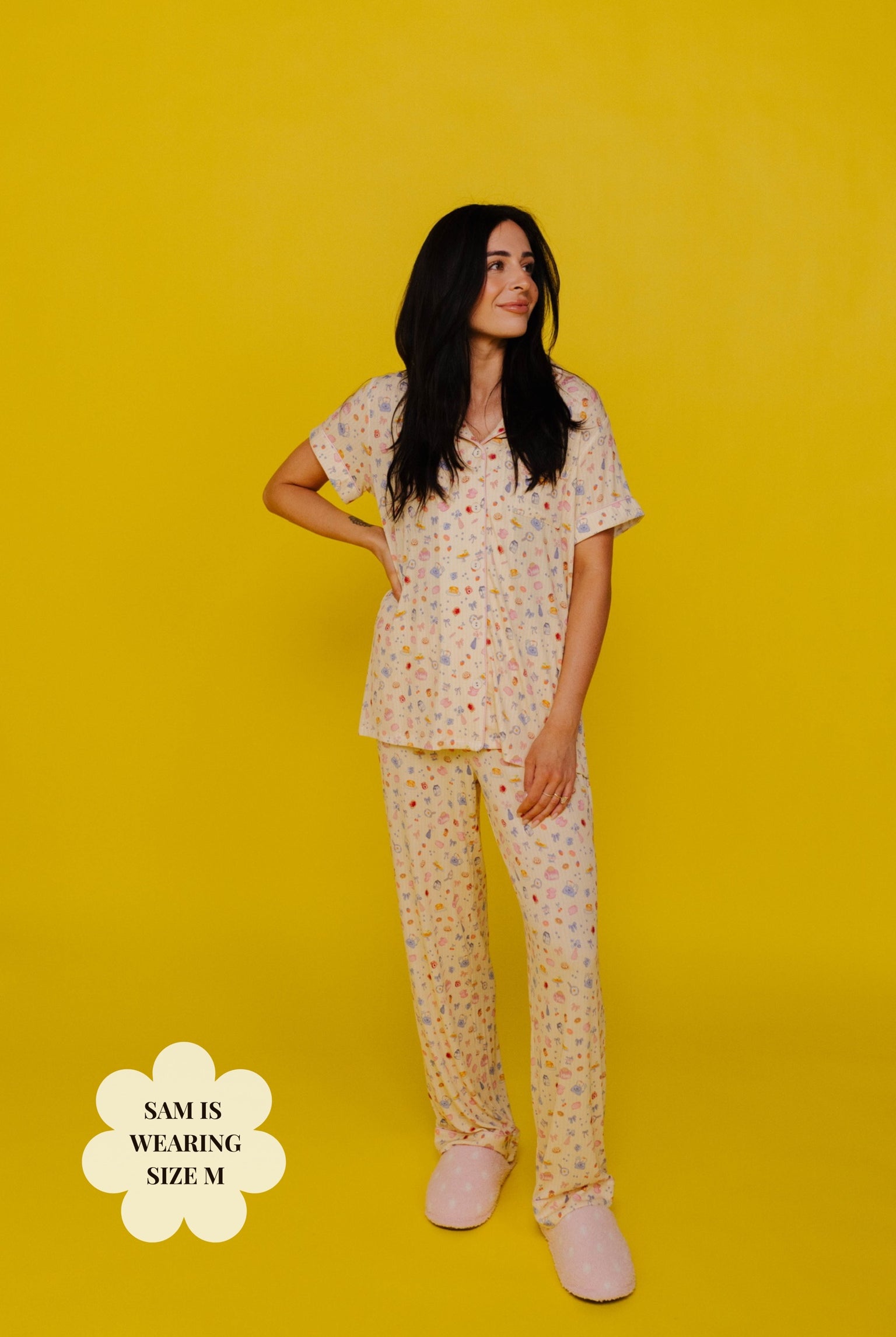 Sam wearing a size M pj standing against a yellow background