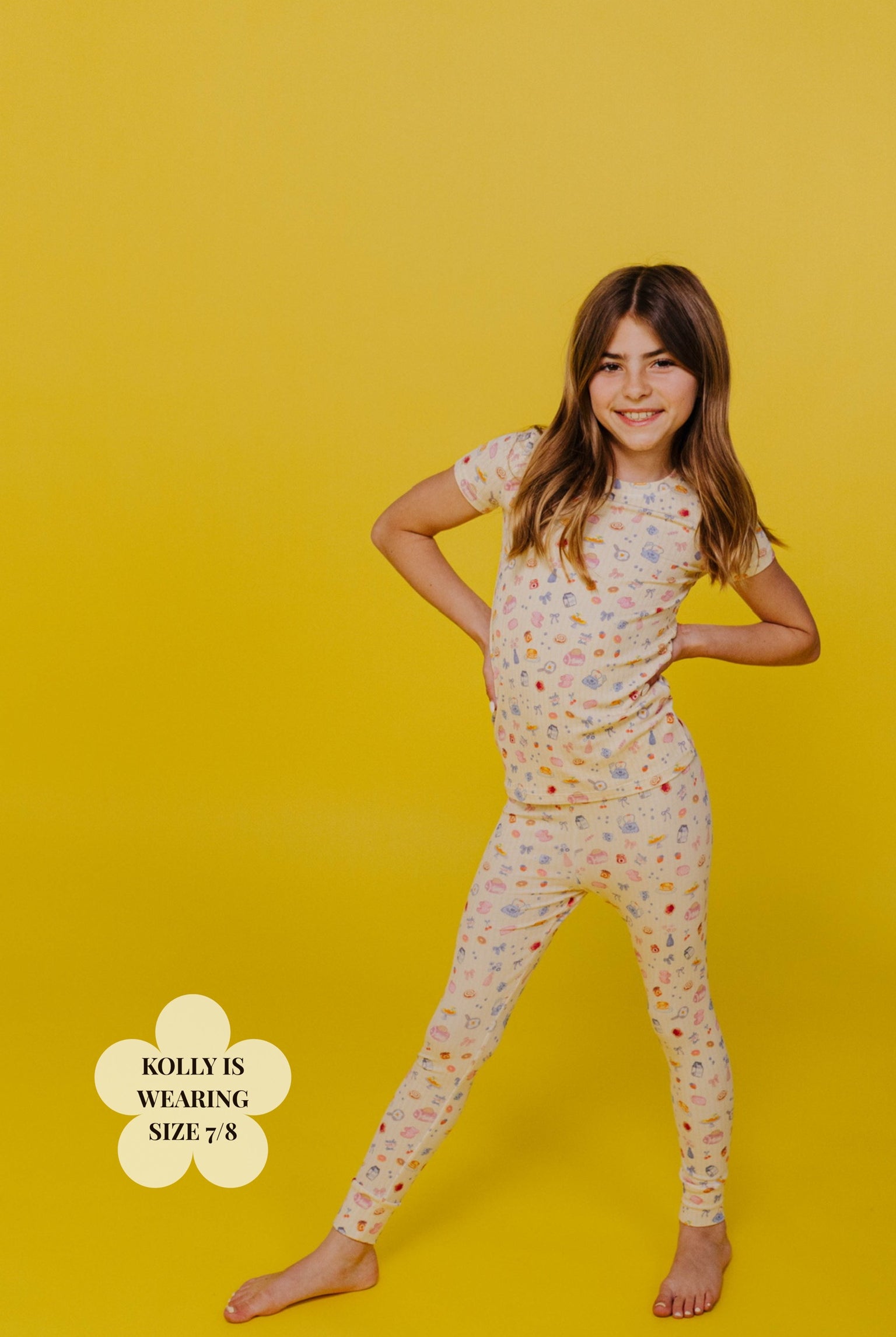 Young girl wearing a brunch pj set on a yellow background