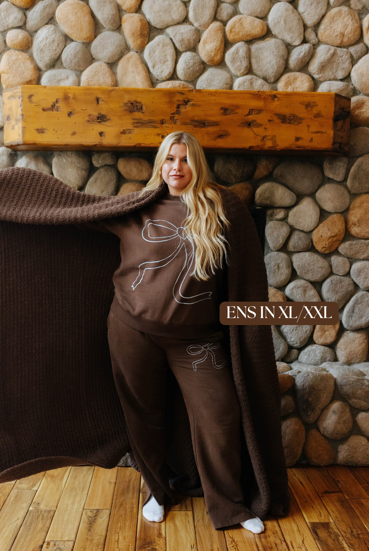 Sizing photo: Ens in XL/XXL wearing brown sweatshirt with blue bow and matching sweatpants.