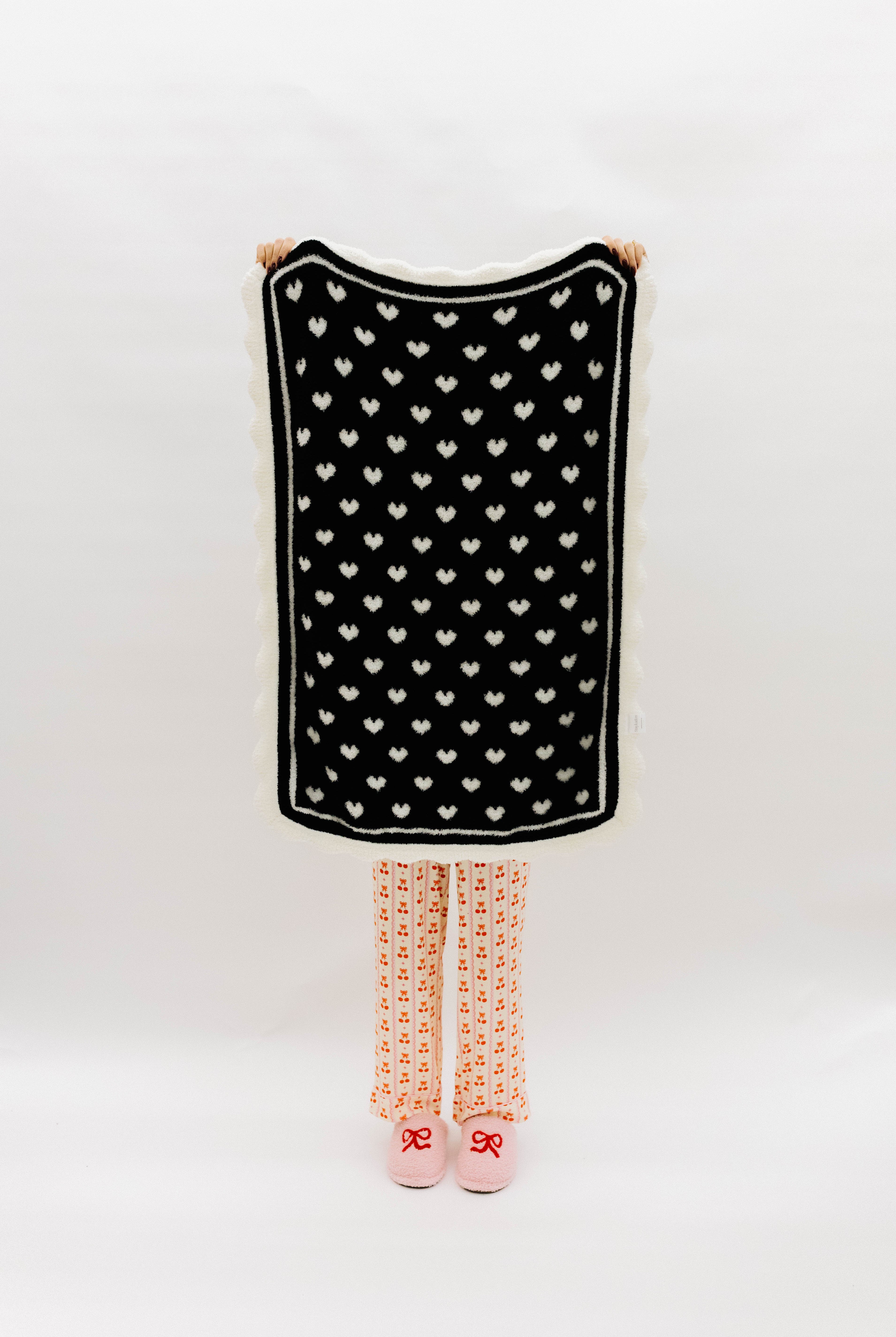 Black side of blanket with white hearts