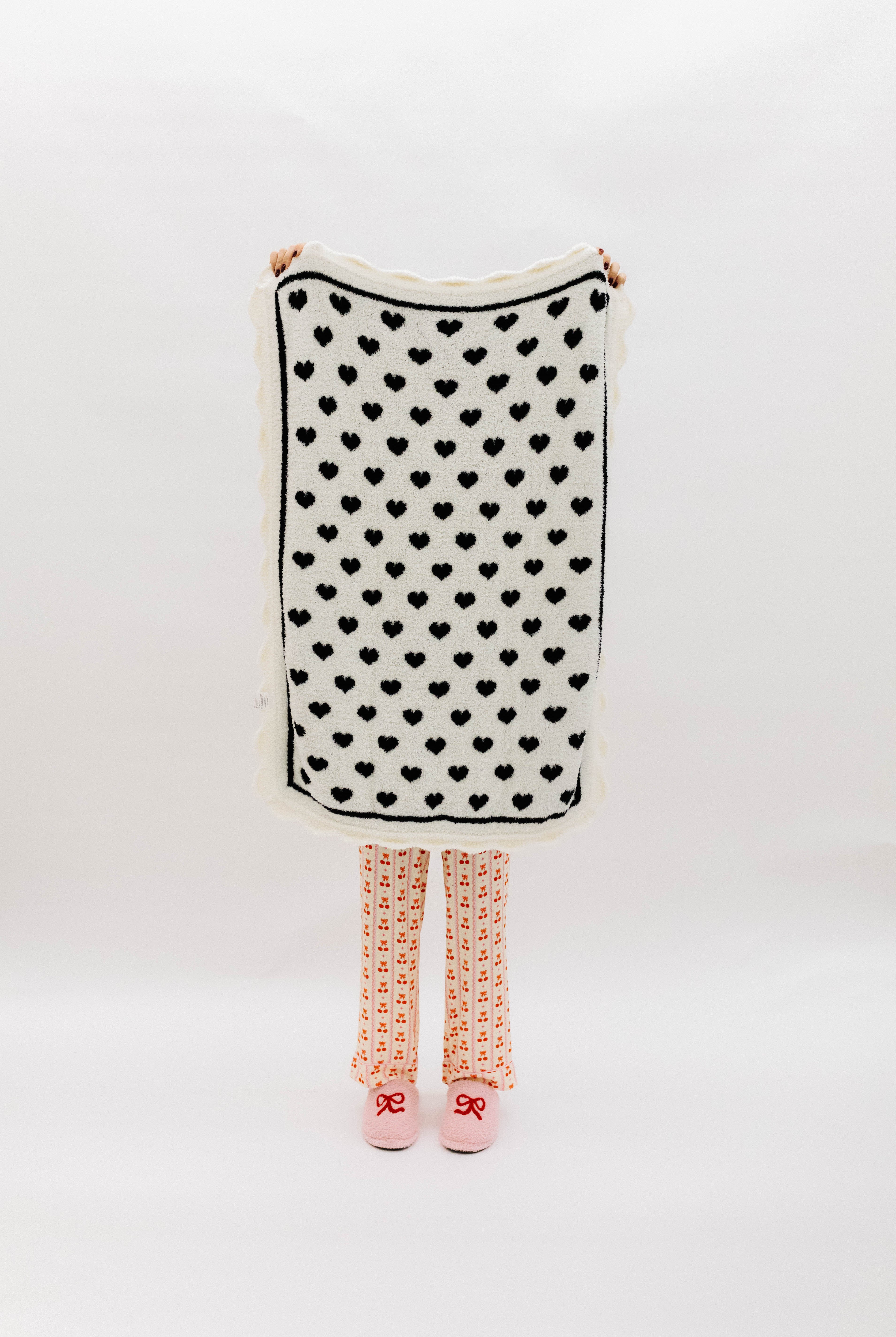 White side of blanket with black hearts