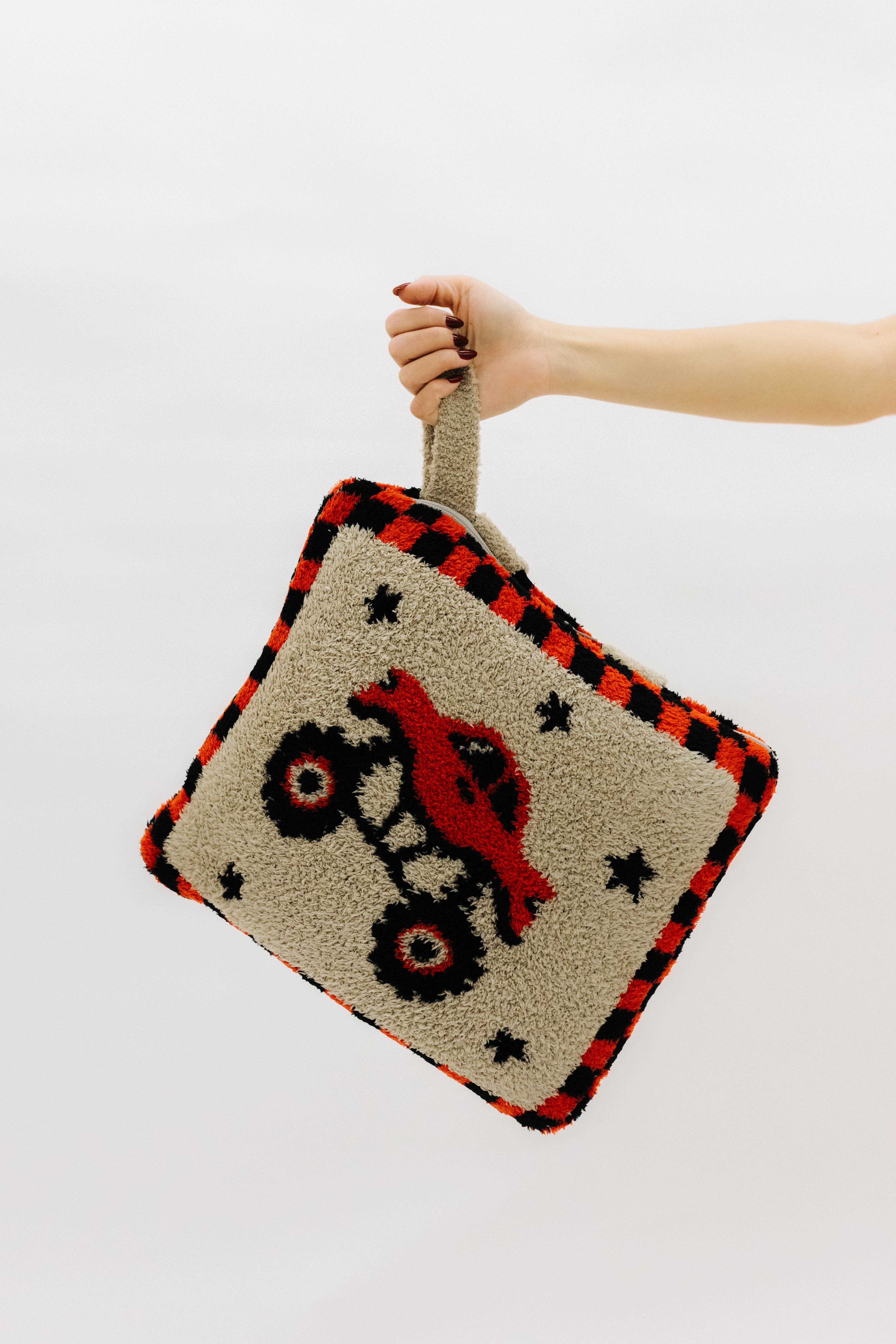 Holding the monster truck quillow by the wristlet