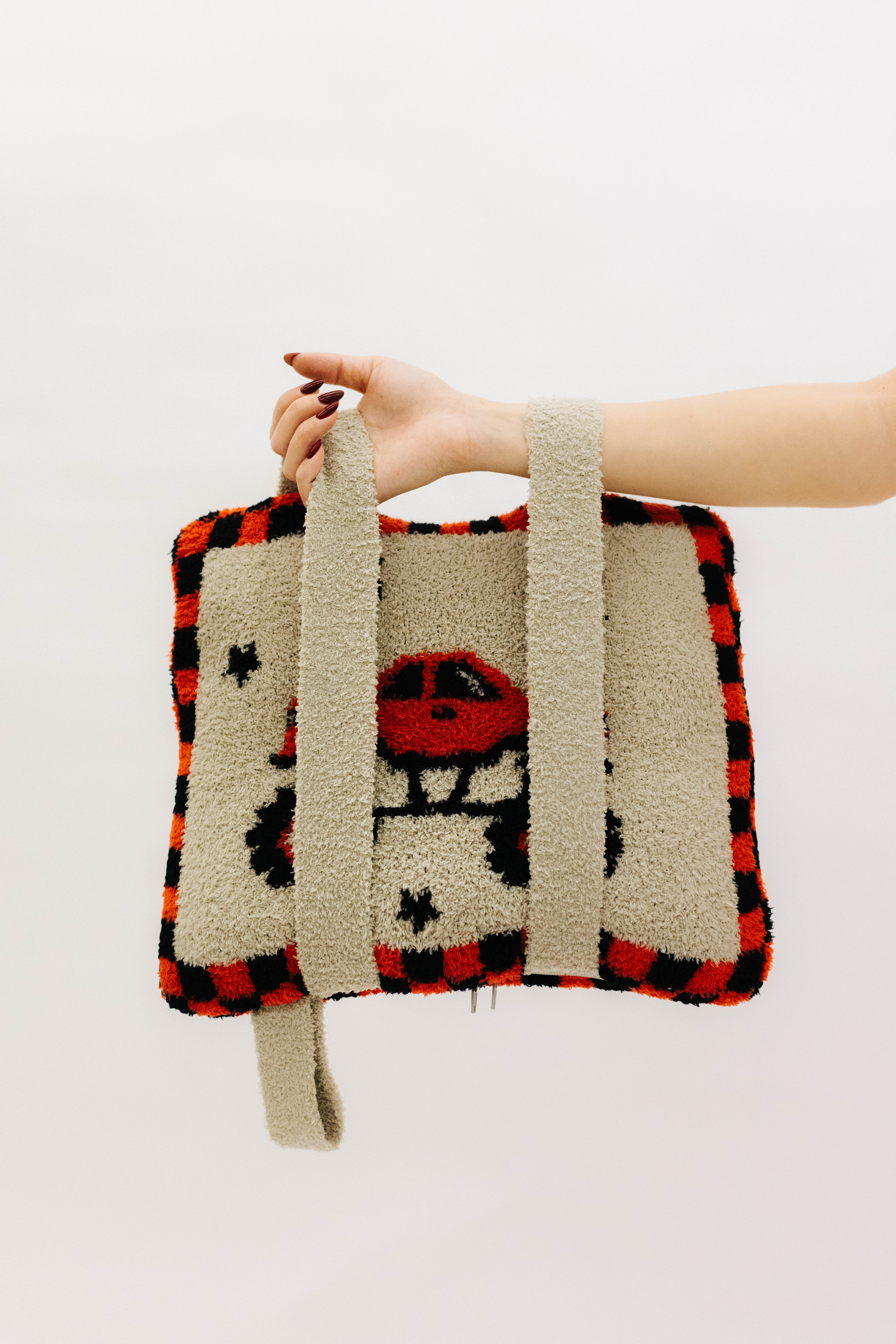 holding the monster truck quillow by the backpack straps