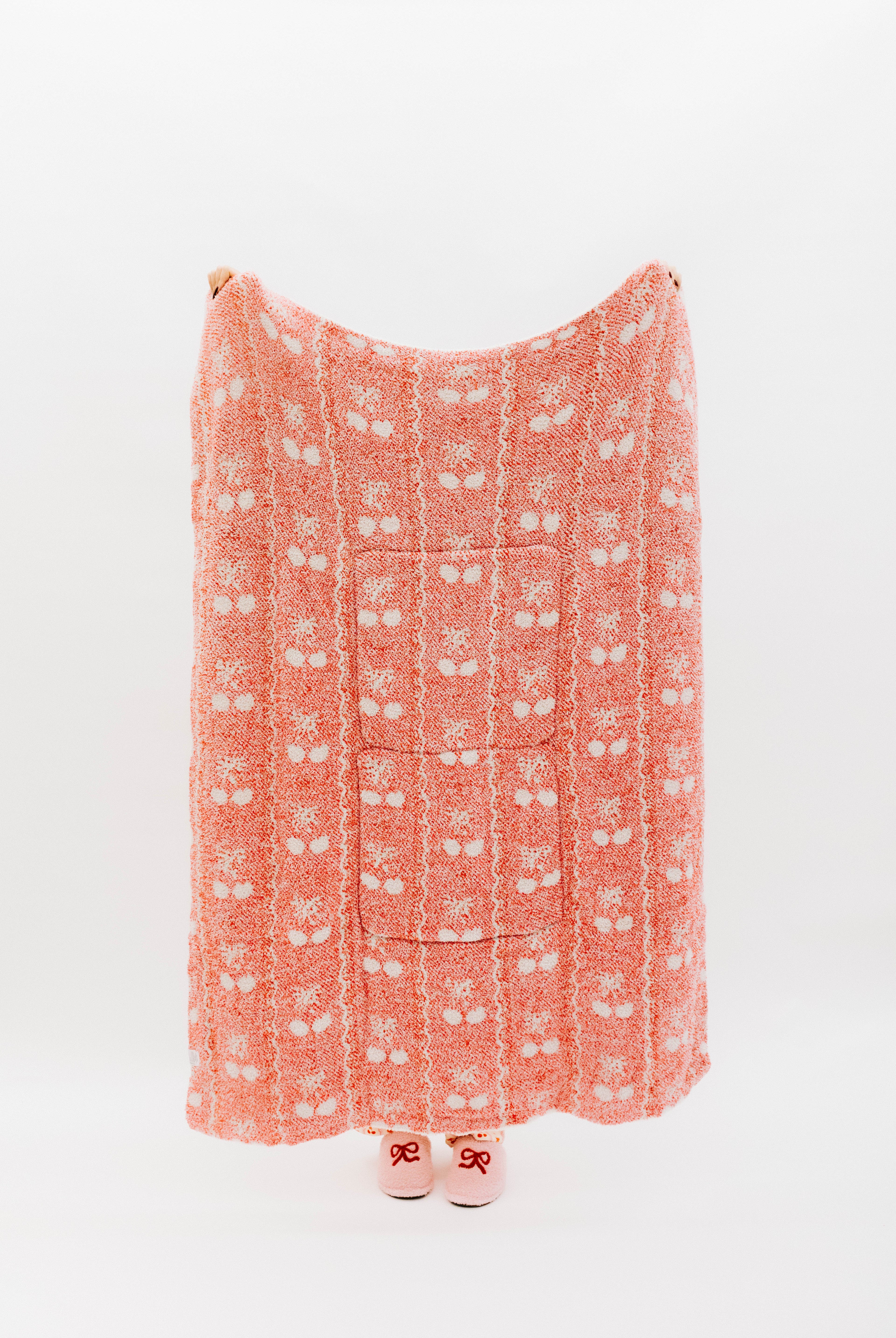 Holding the cherry bow quillow so it shows the full size (back side)