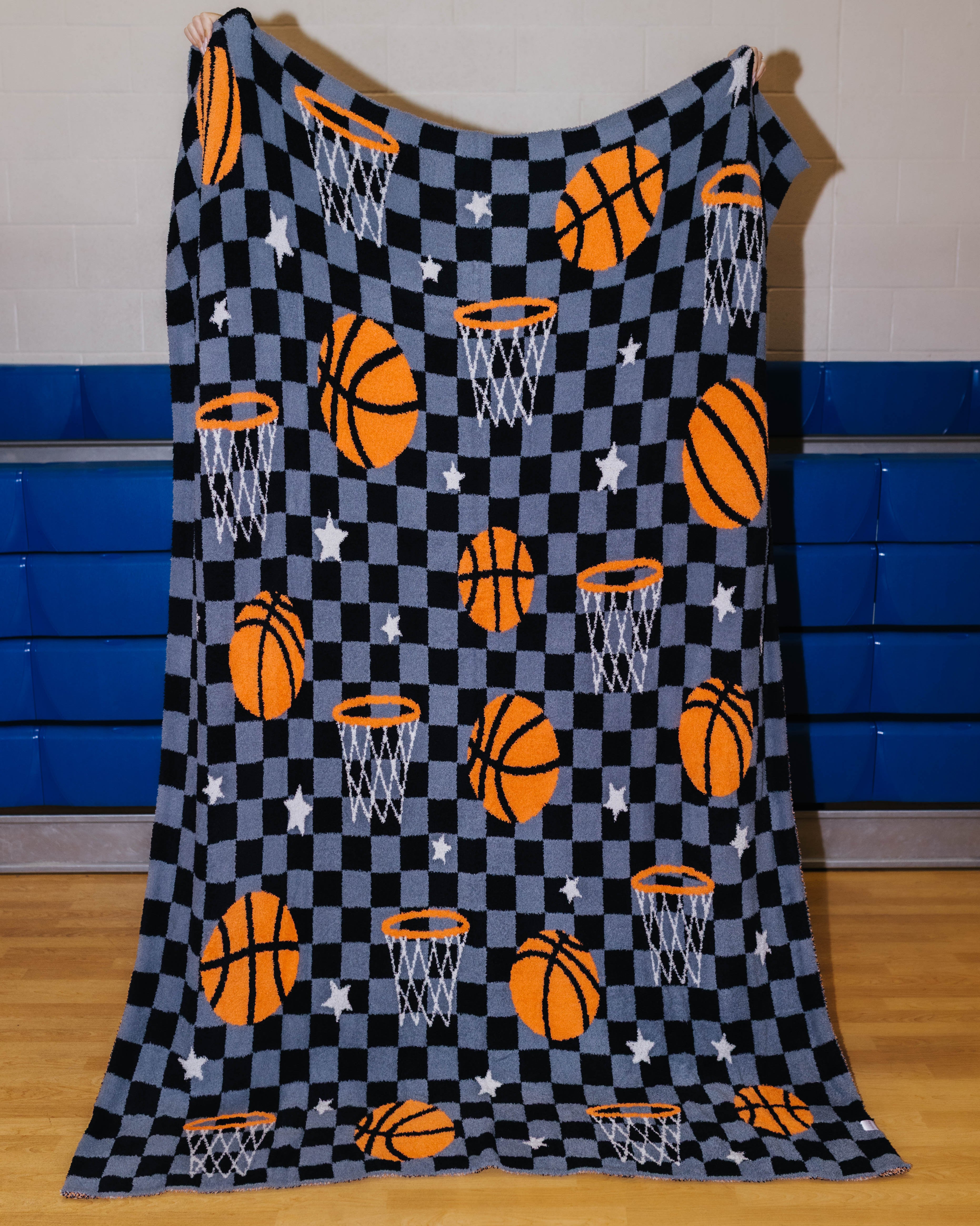 front of basketball blanket that has basketball, stars, hoops, and black/grey checkers