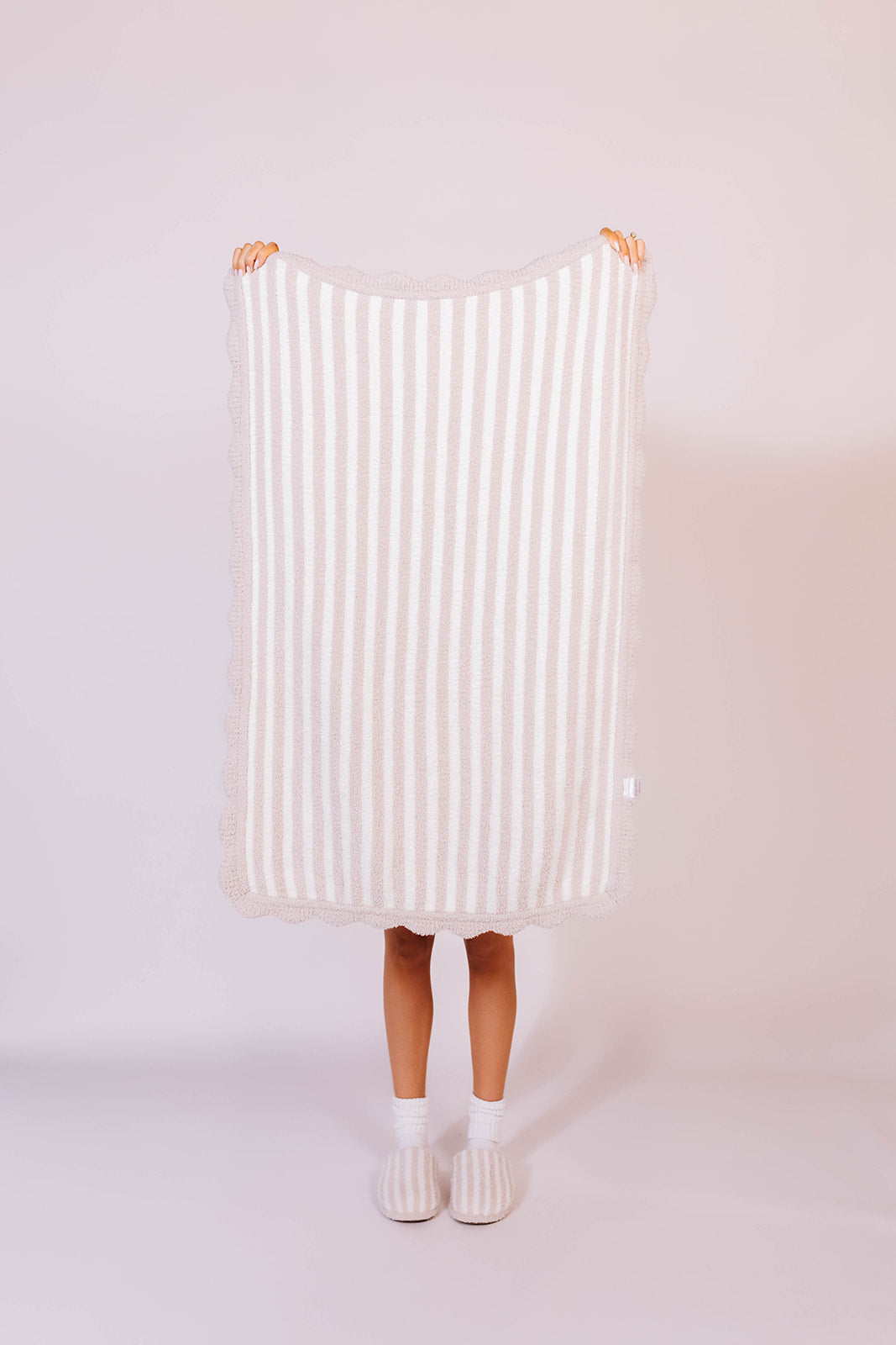 holding up the pinstripe blanket to see the detailing