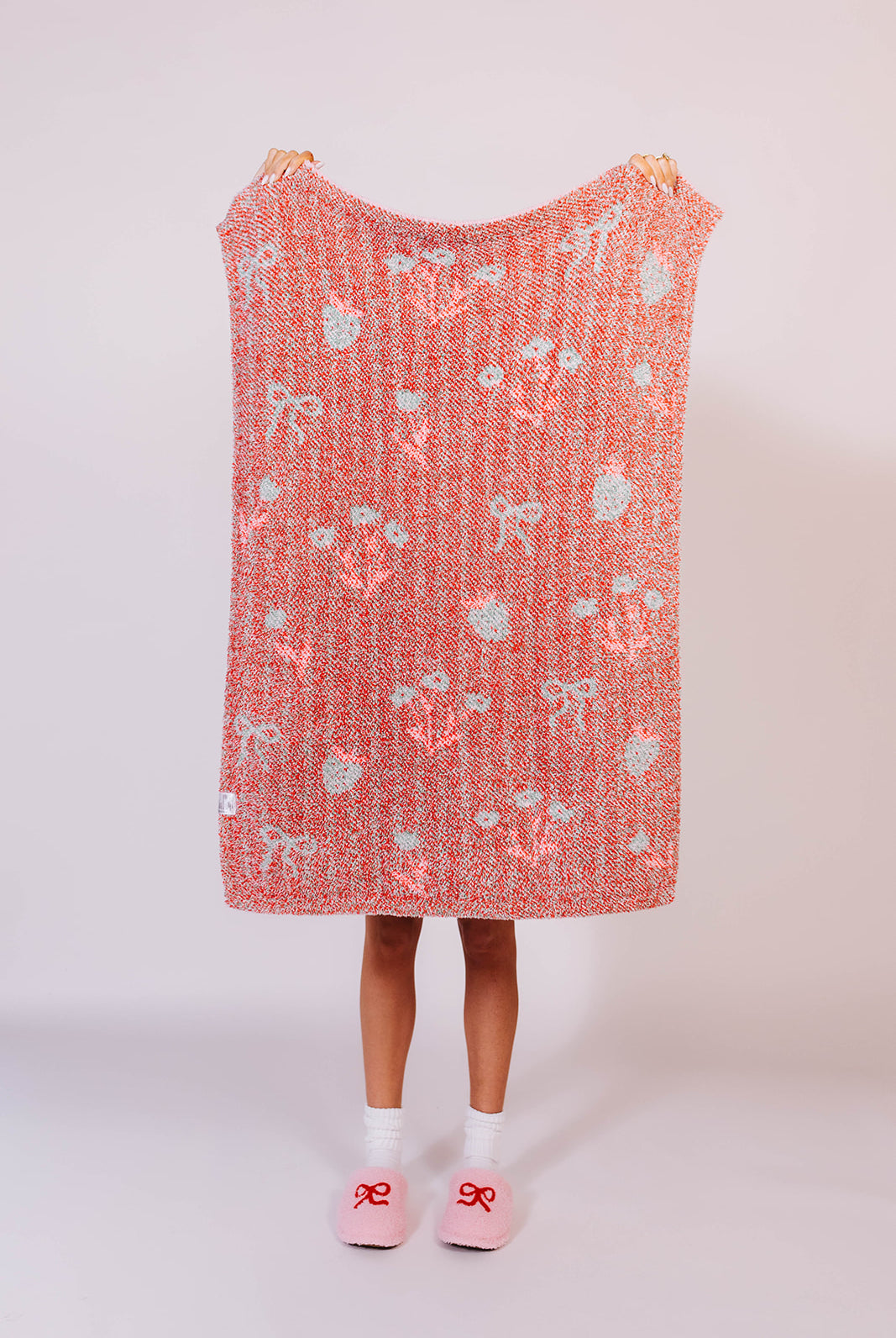 Showing strawberry striped kid blanket back- holding it up to see details