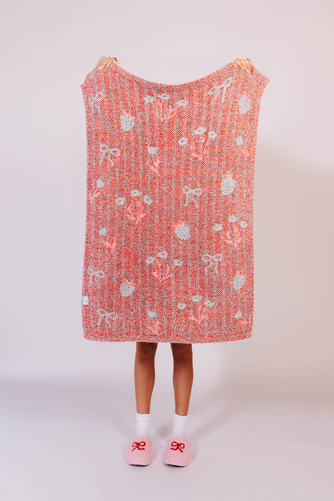 Showing strawberry striped kid blanket back- holding it up to see details