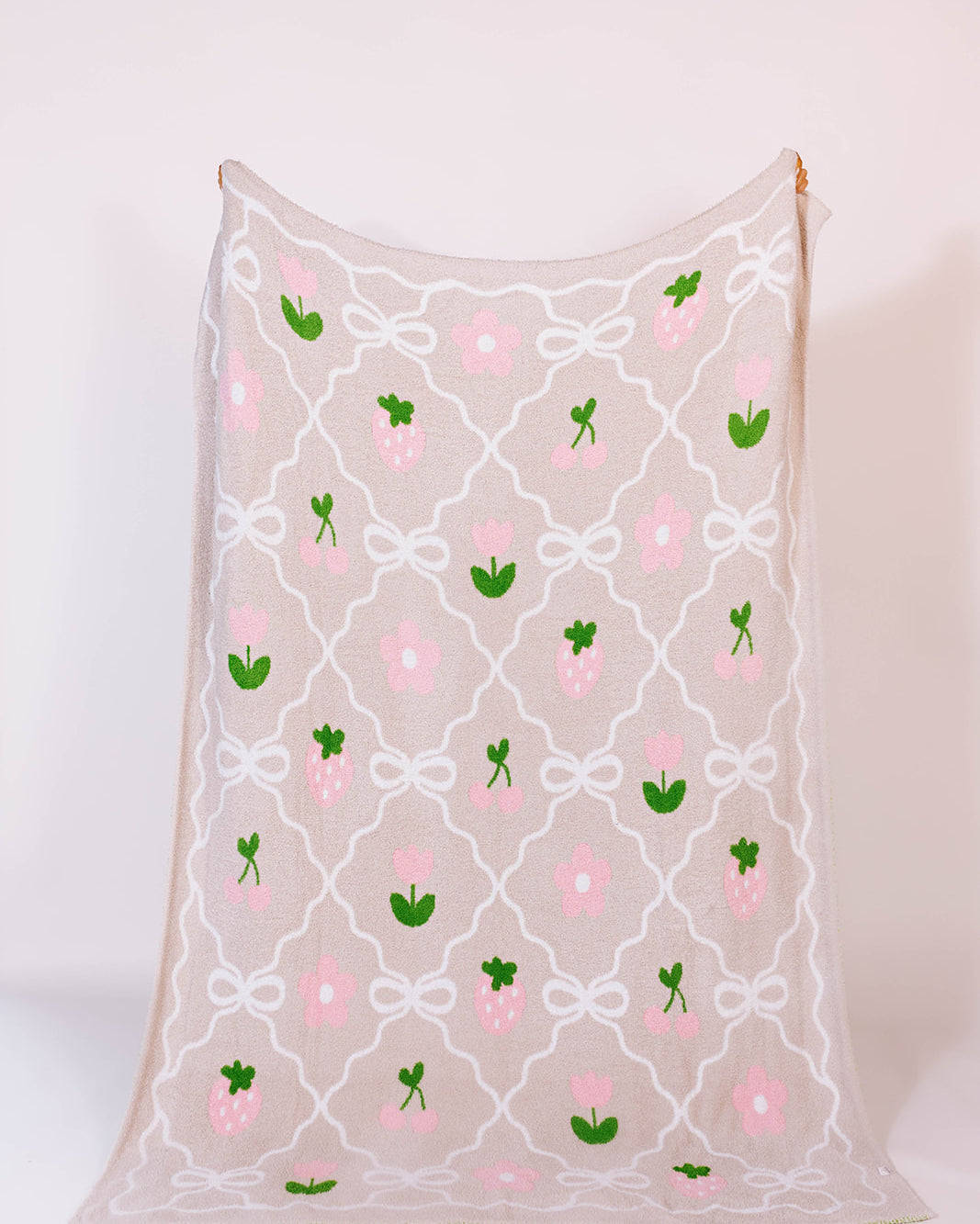 60*80 blanket with floral and bow pattern on a white background