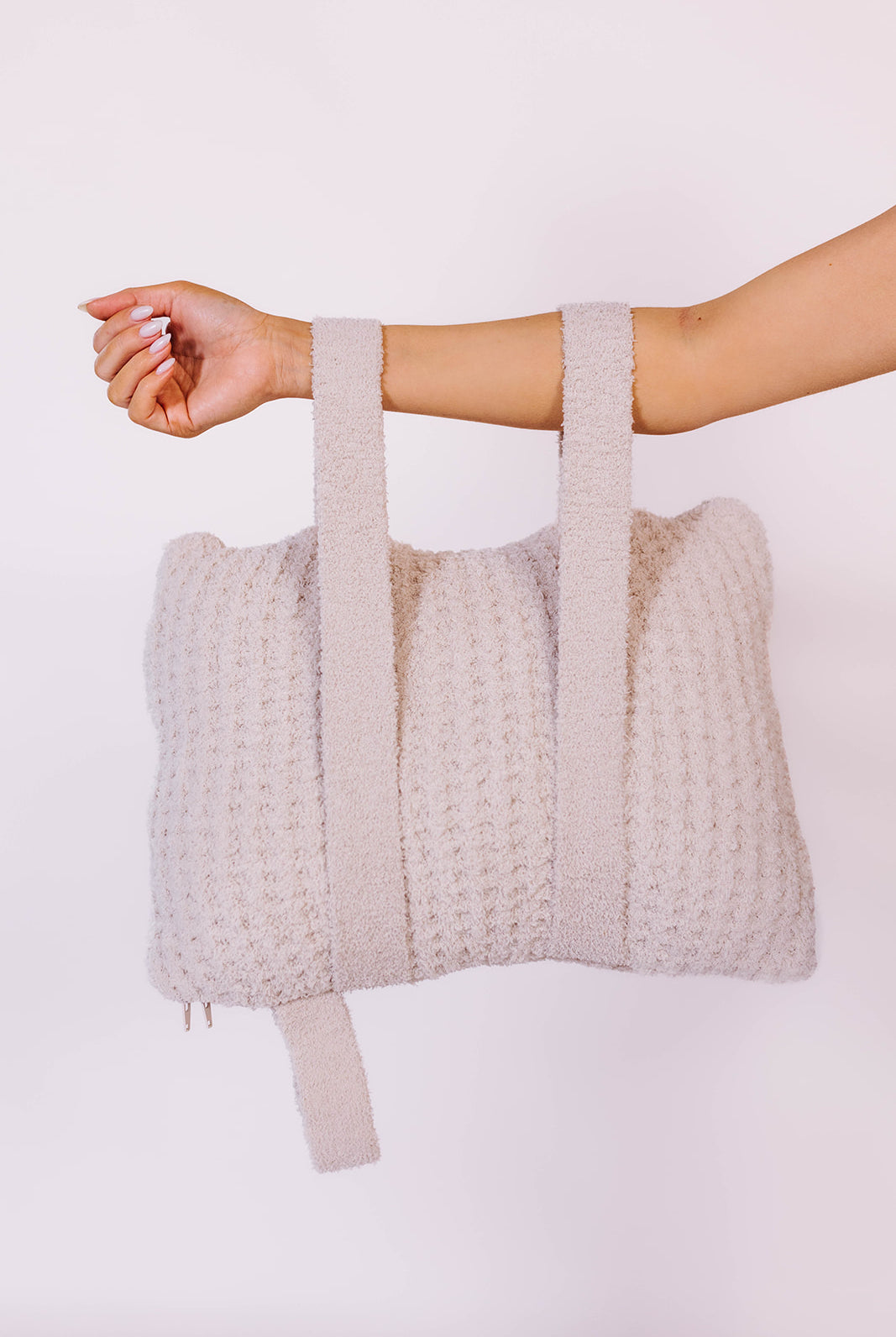 holding the quillow by the backpack straps