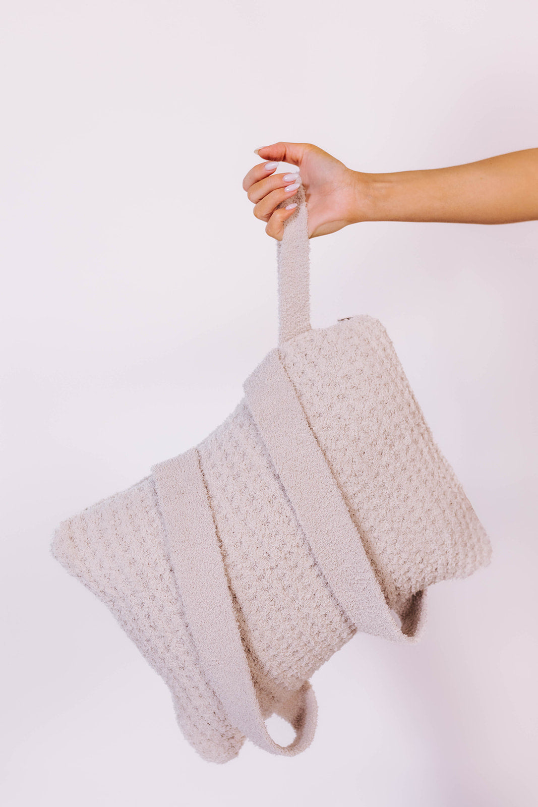 holding the quillow by the wristlet