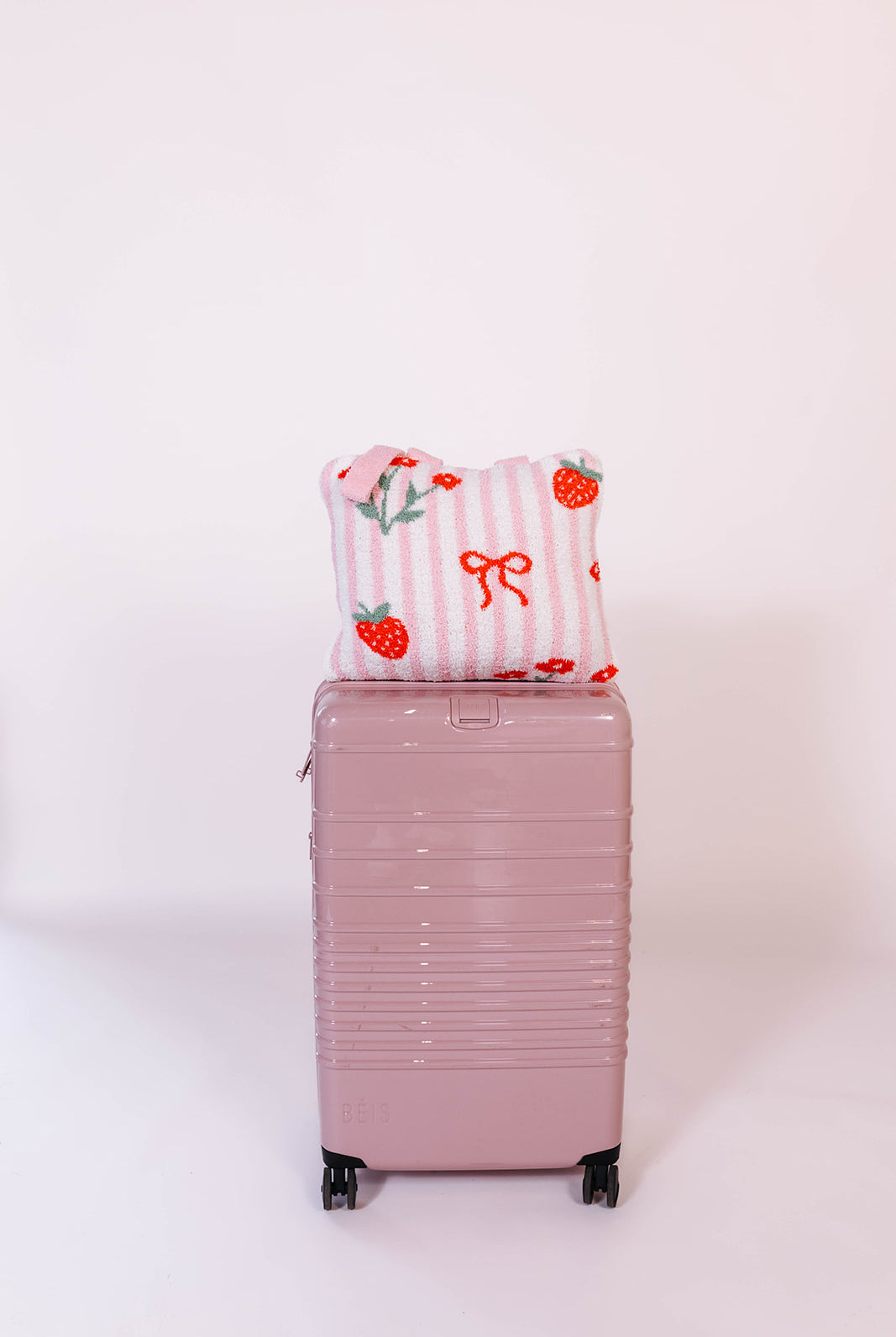 quillow on the pink beis suitcase