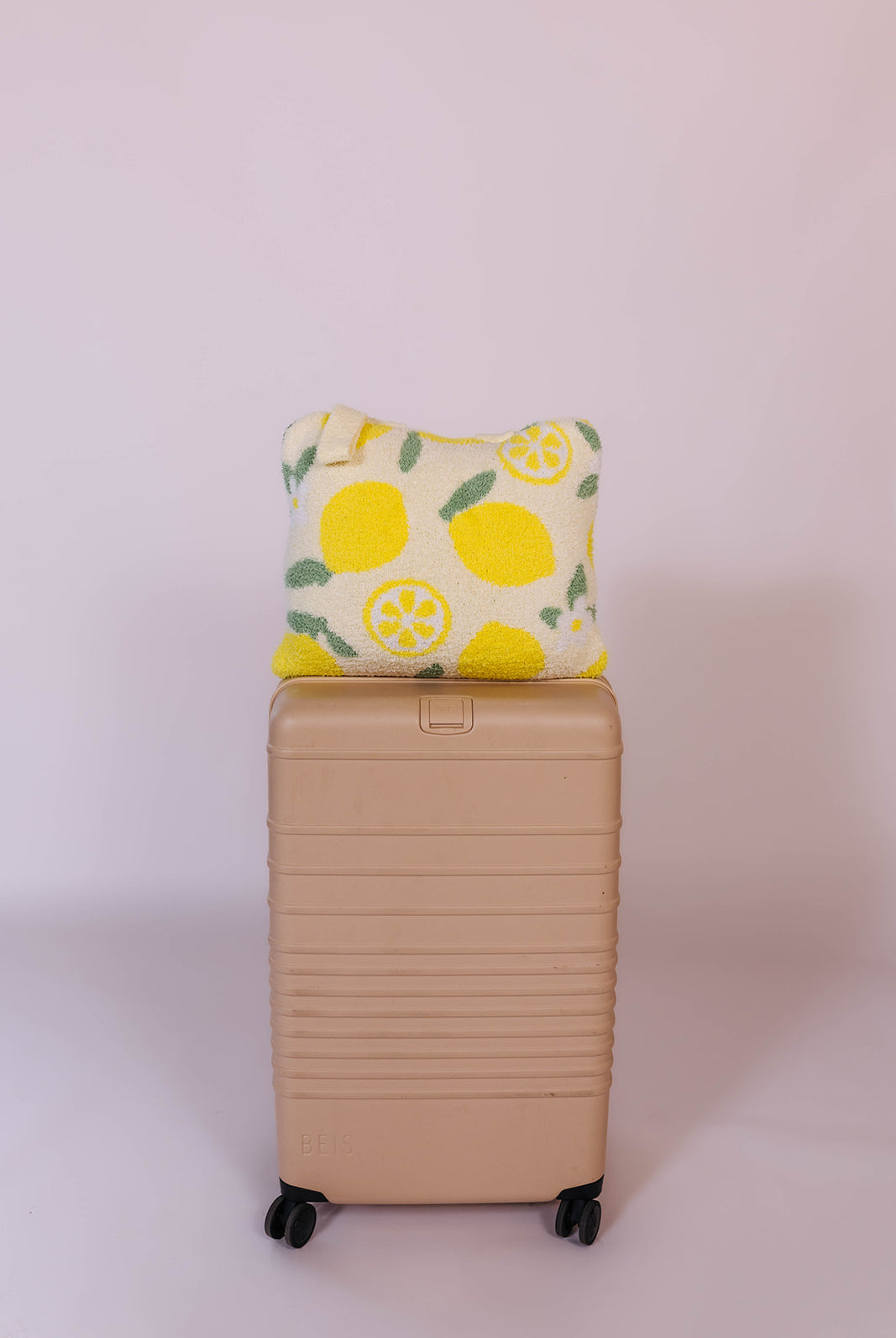 showing the lemon quillow on the suitcase
