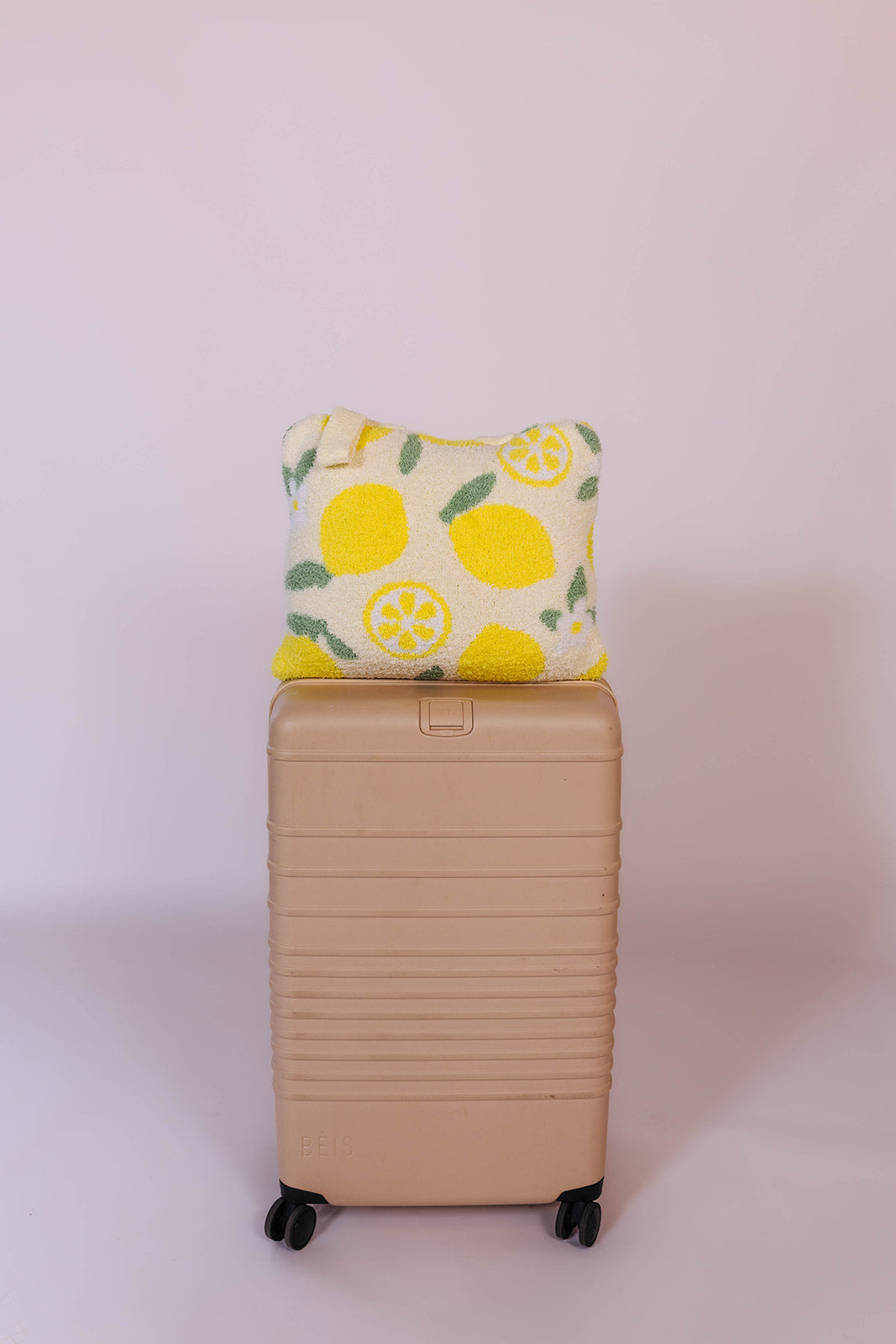 showing the lemon quillow on the suitcase