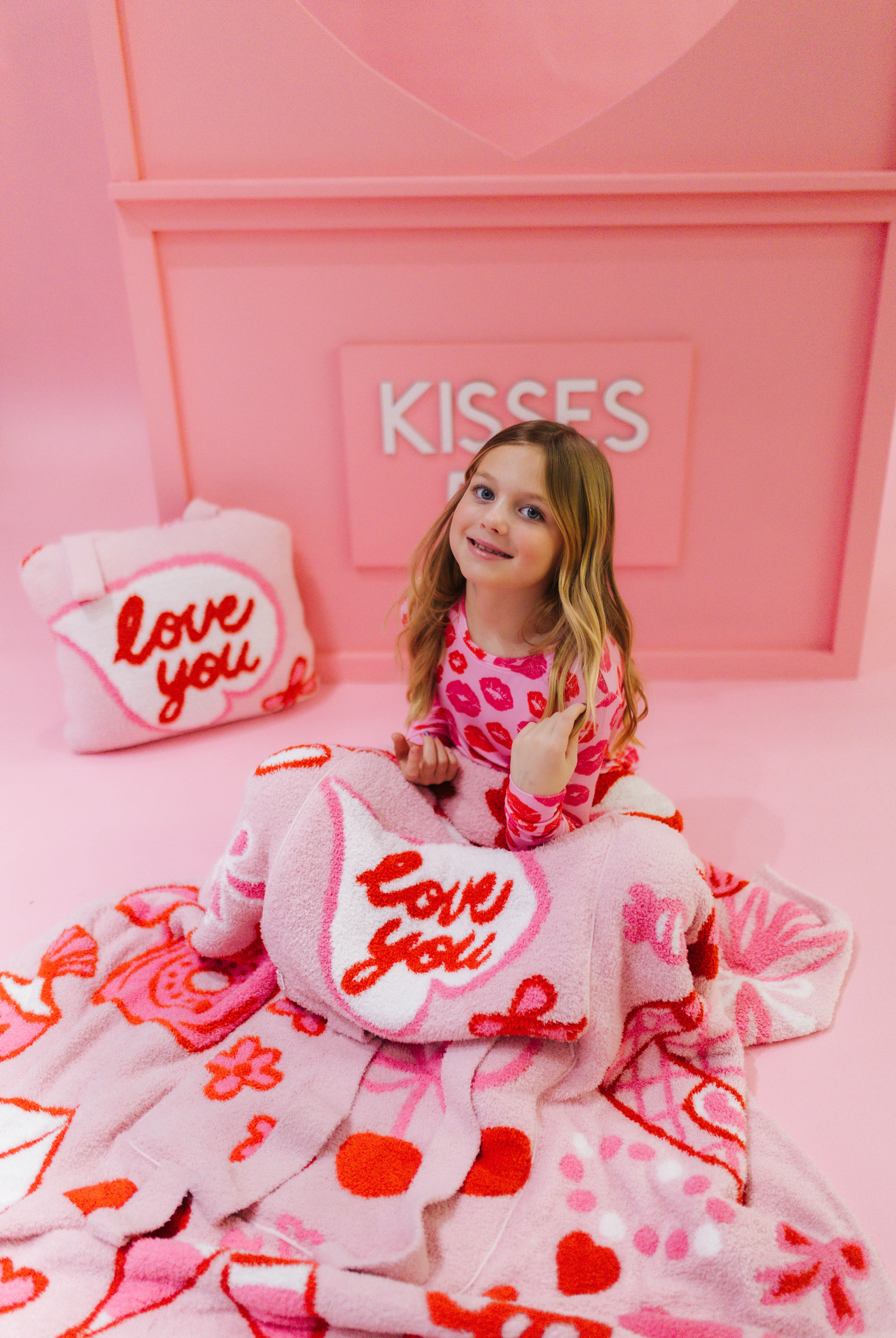 Young girl showing the 'love you' quillows.