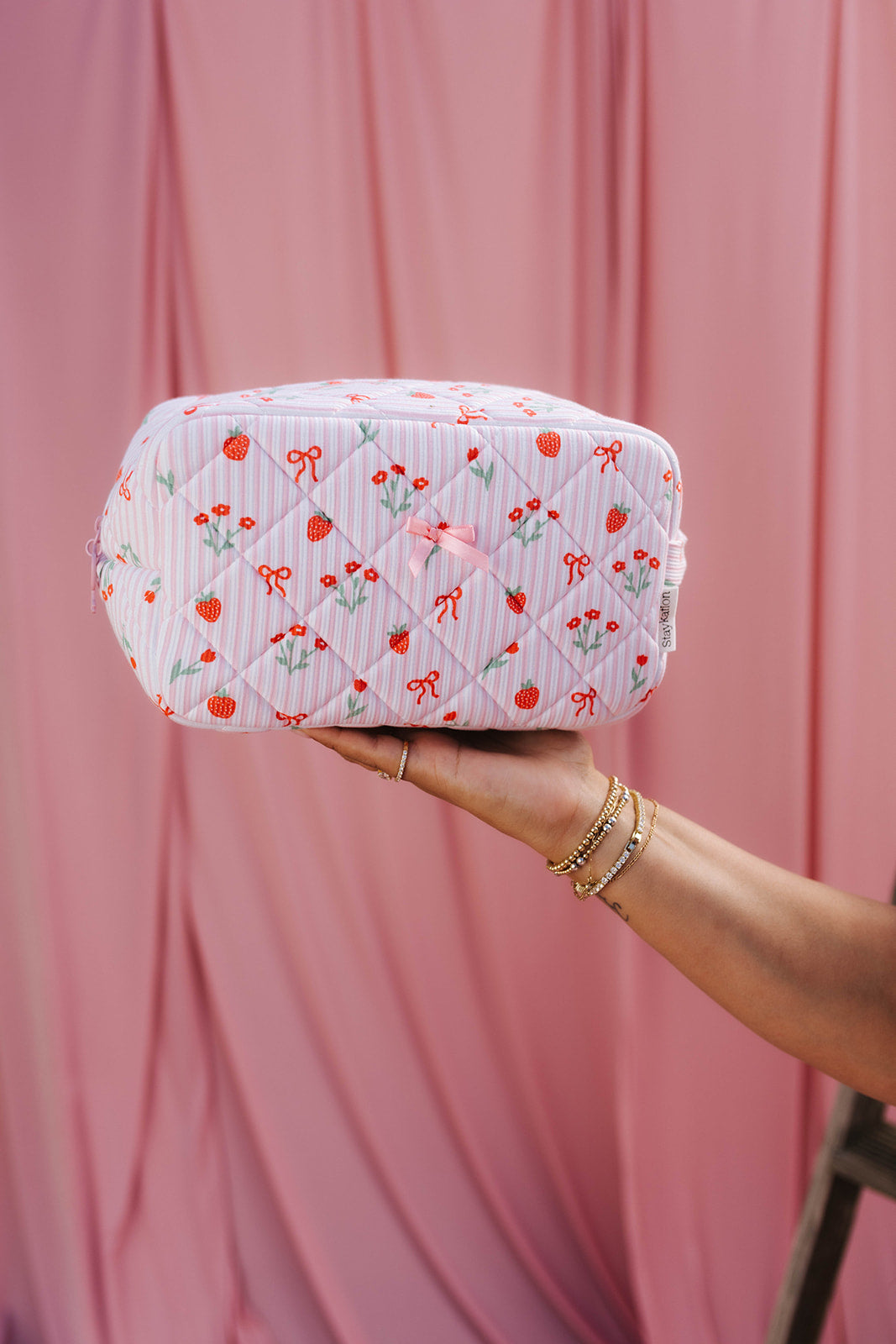 showing the pink ribbon bow on the cosmetic bag