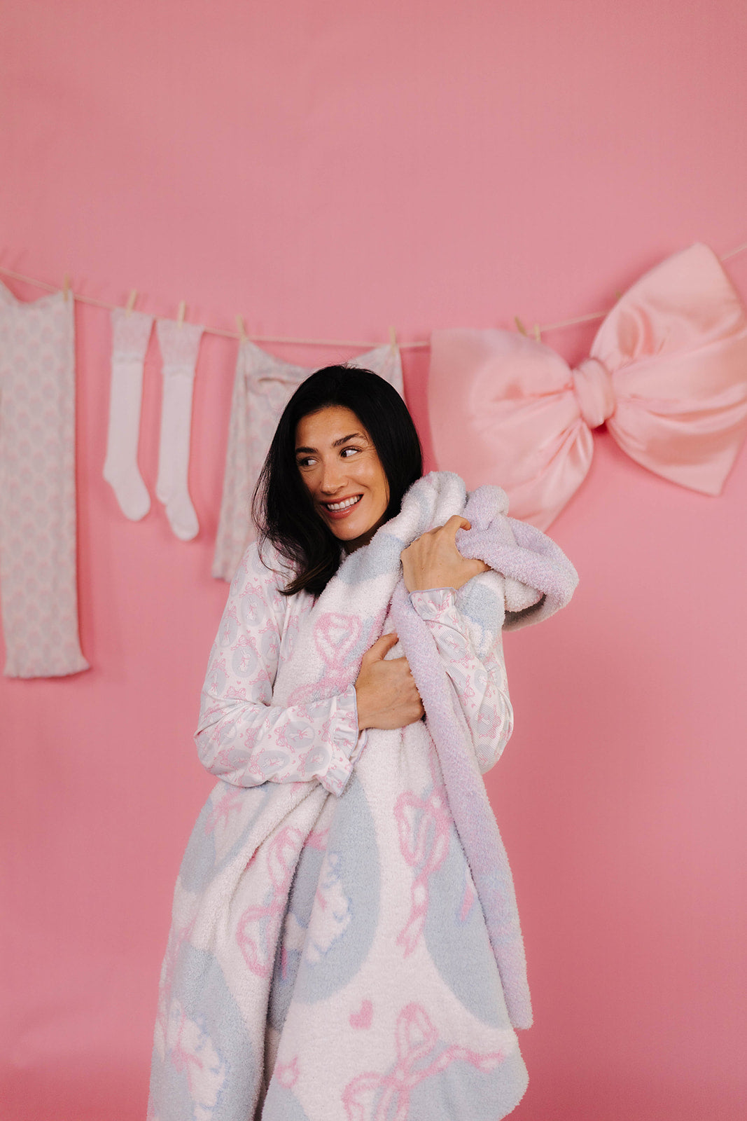 Woman holding bunny and goose blanket.
