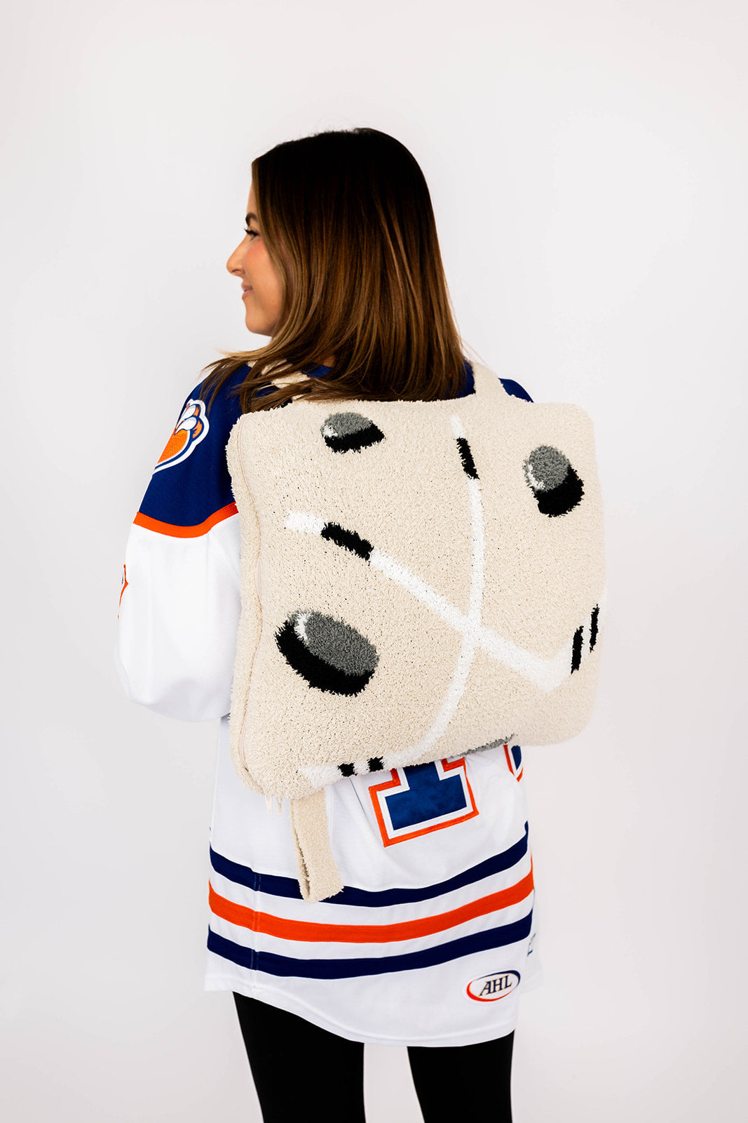 Person wearing a sports jersey and a hockey quillow on the back