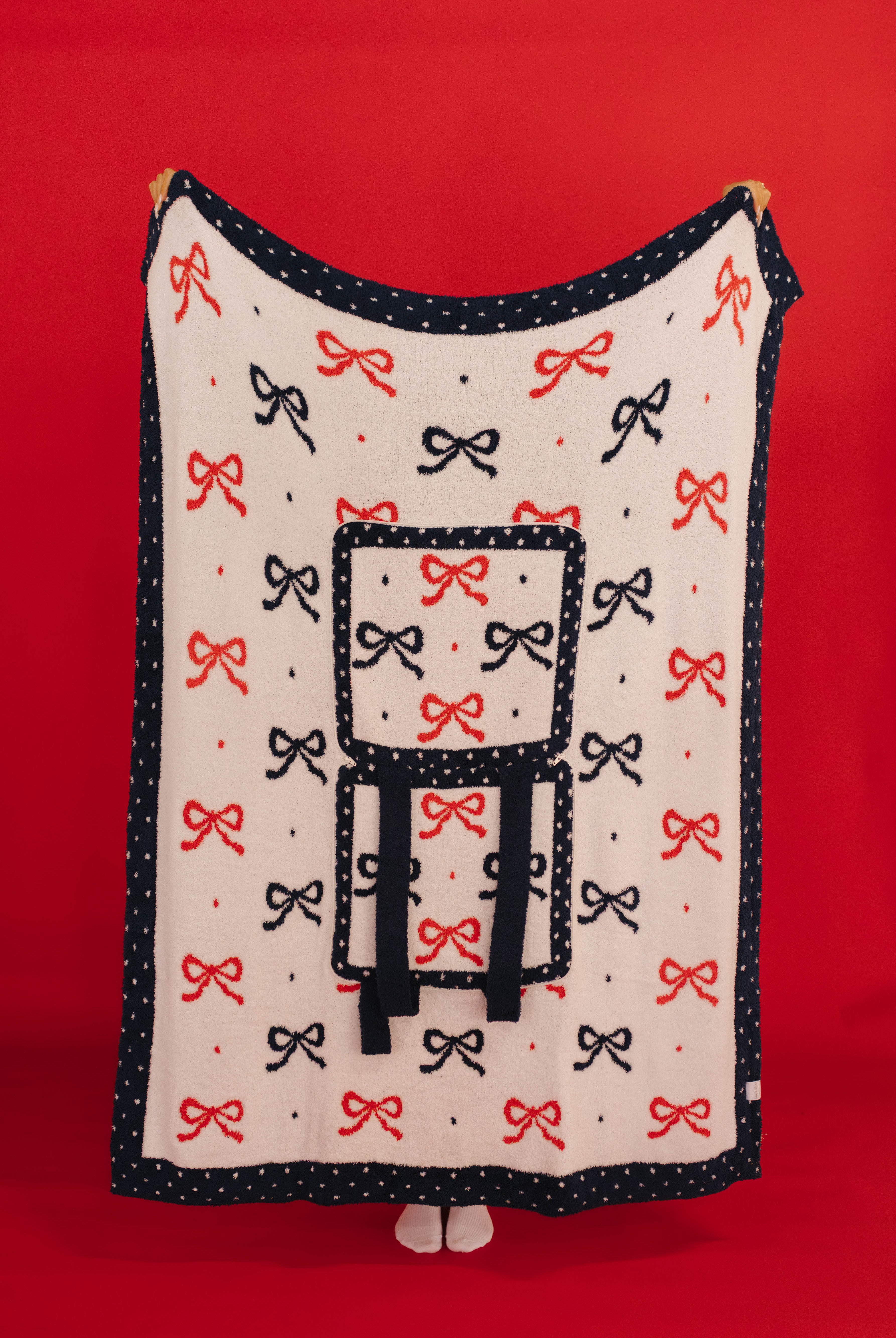 Blanket with bow pattern on a red background