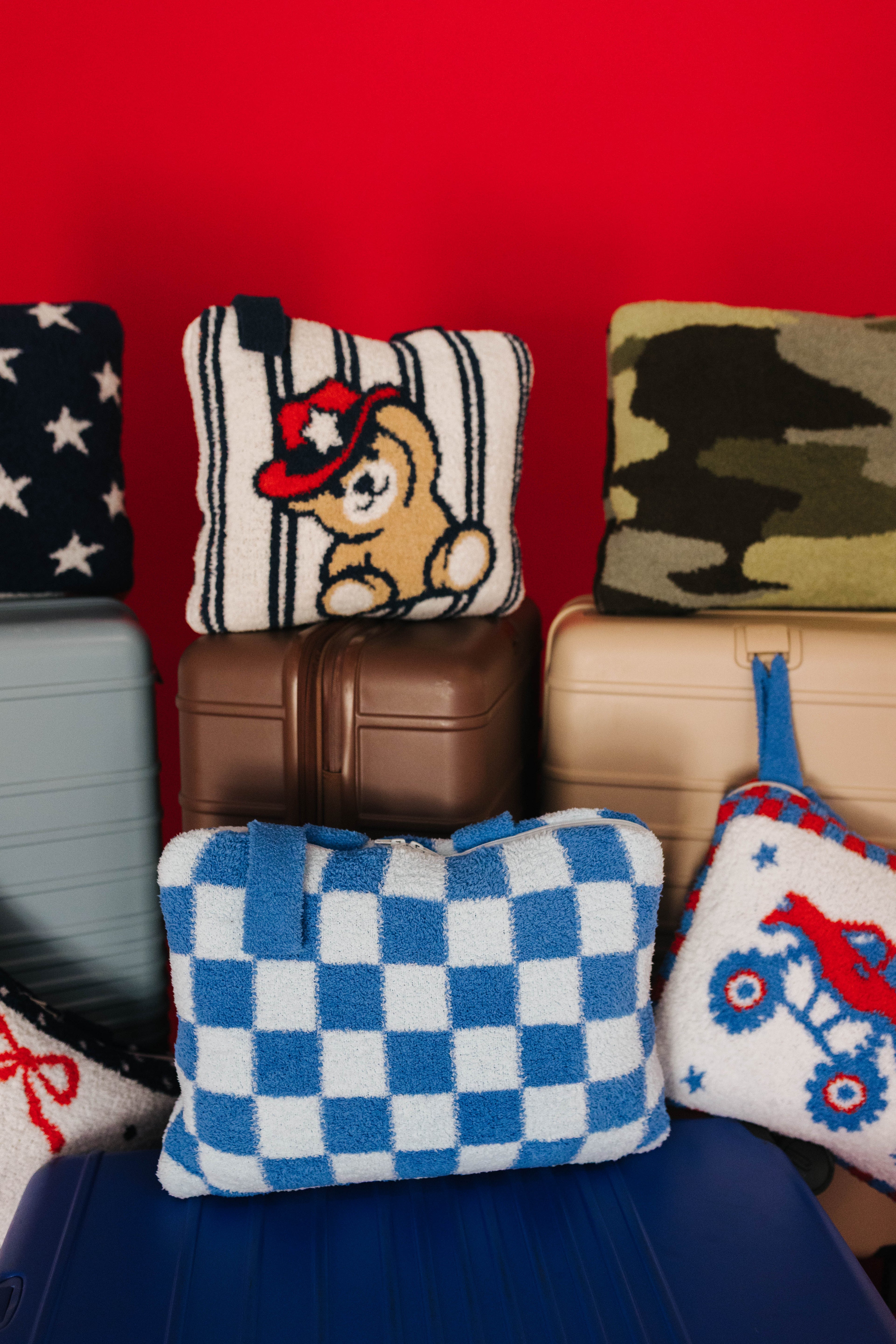 close up of multiple quillow styles on suitcases