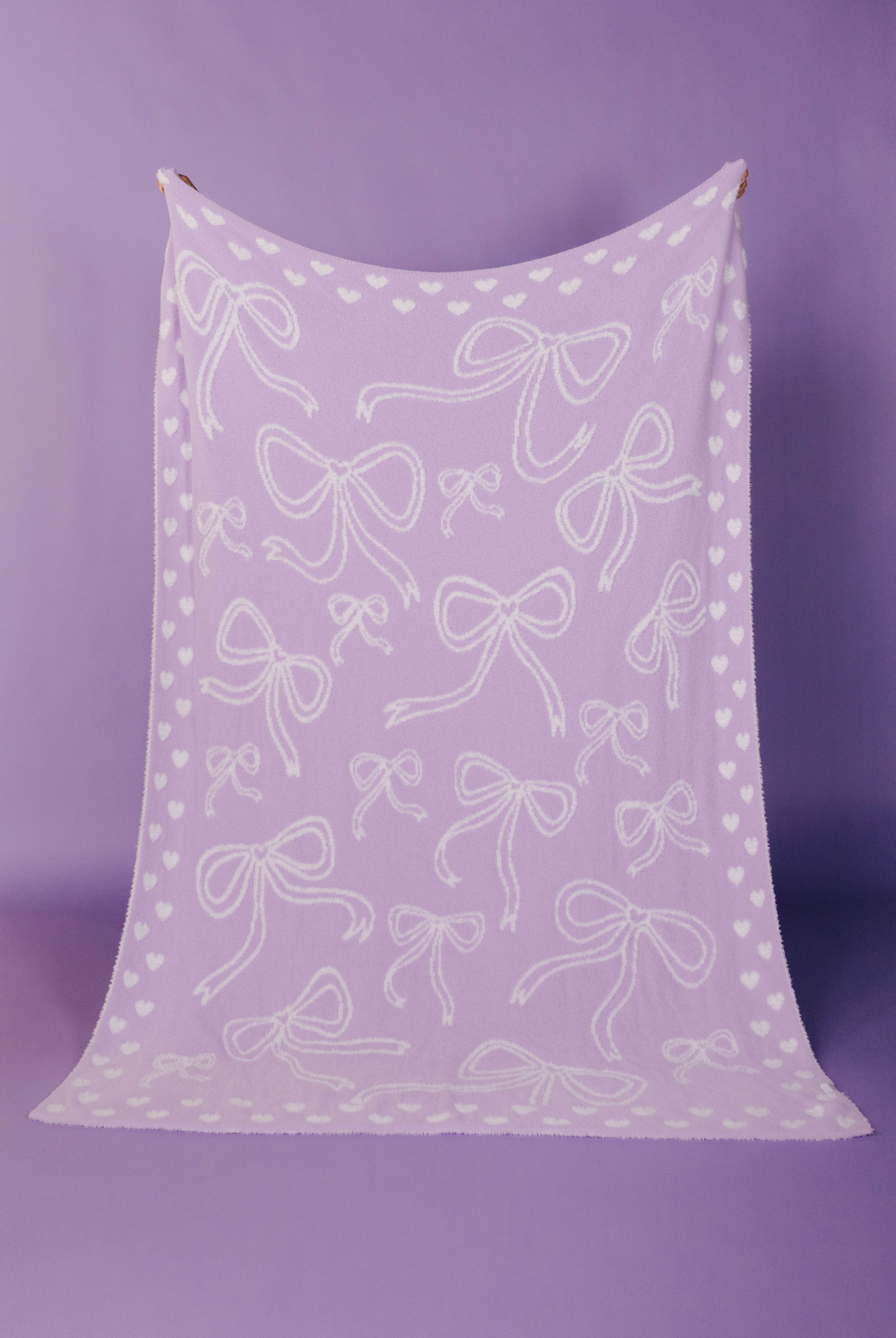 front of purple bow blanket