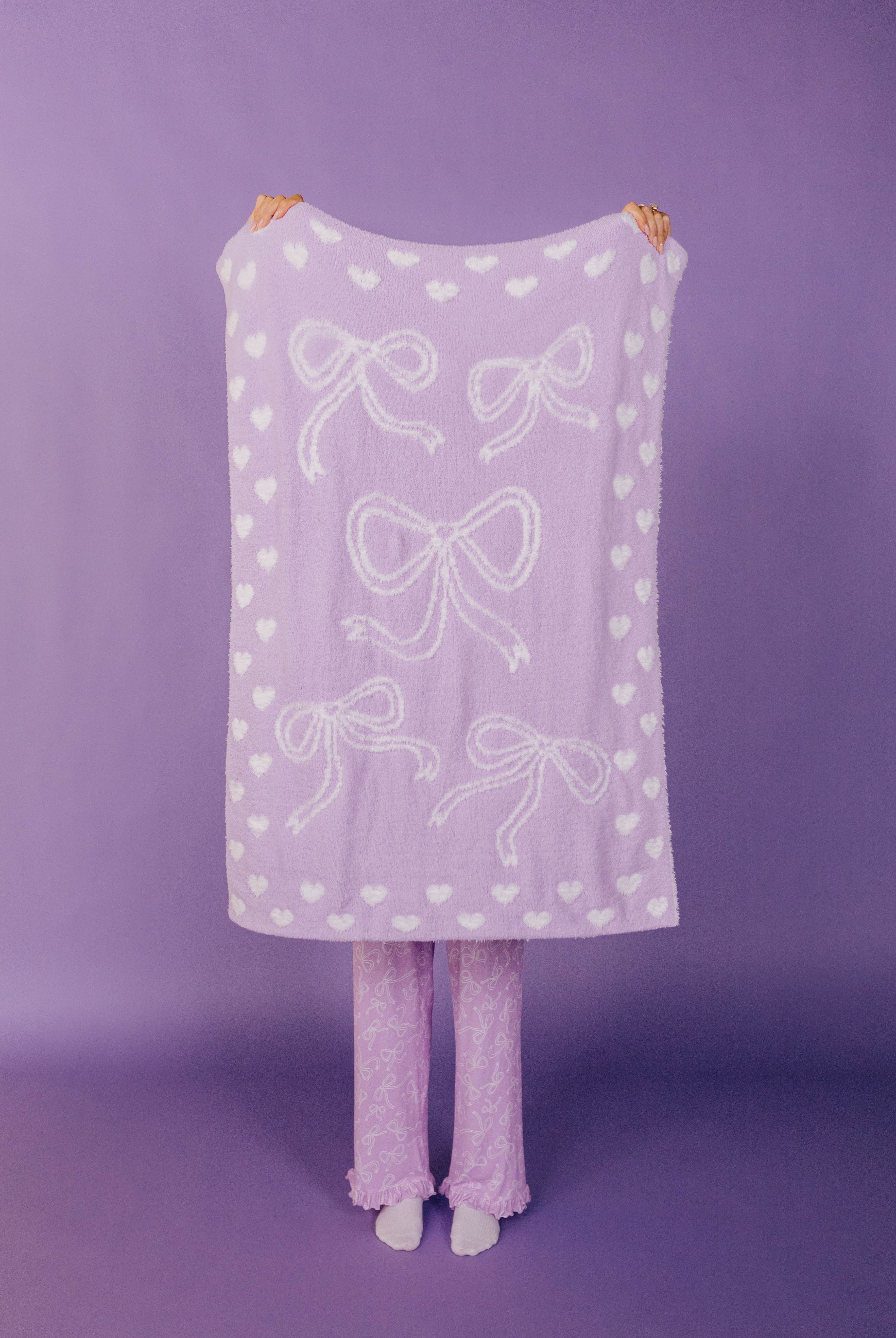 front of the purple bow blanket