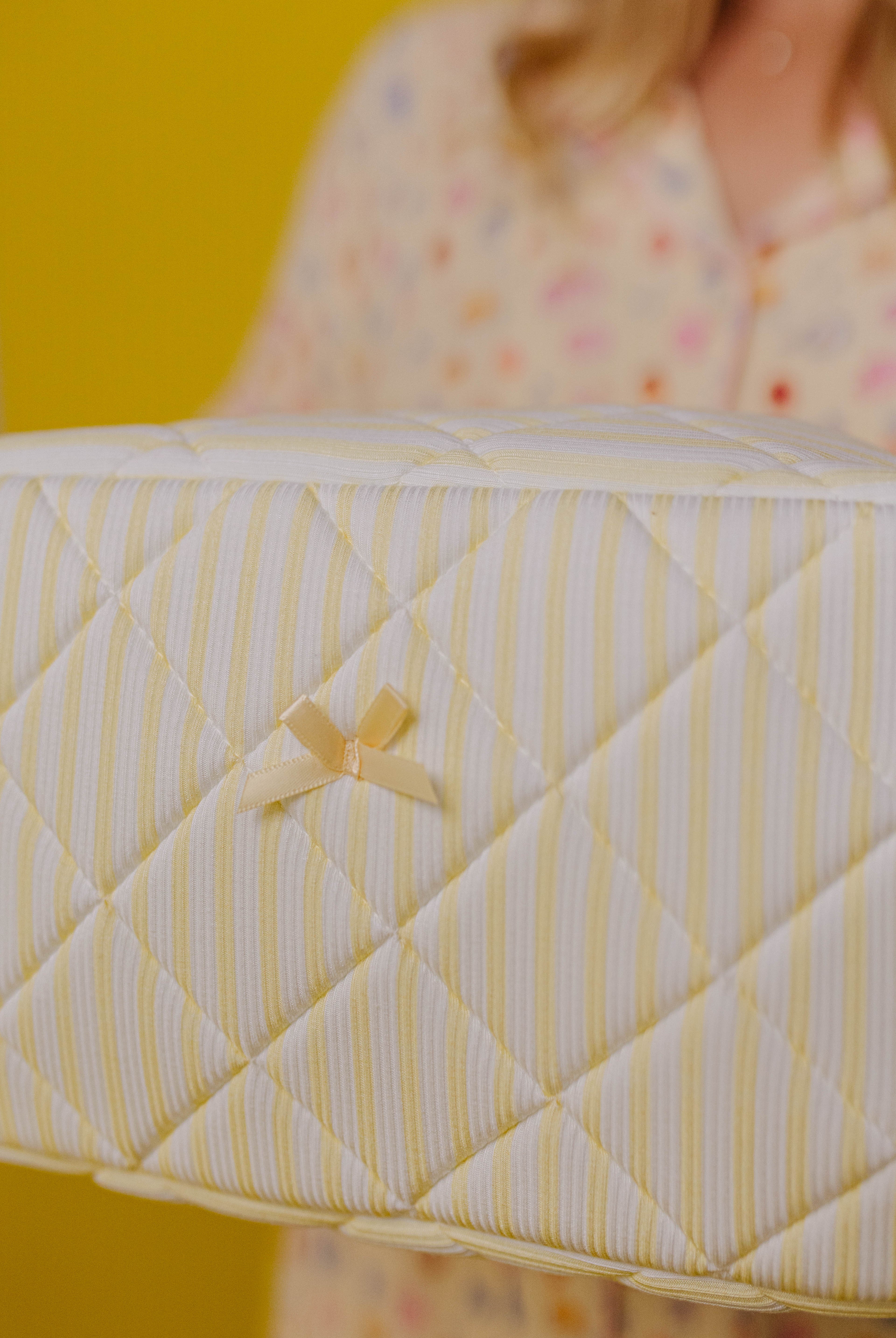 showing the bow detailing and stripe detailing on the bag