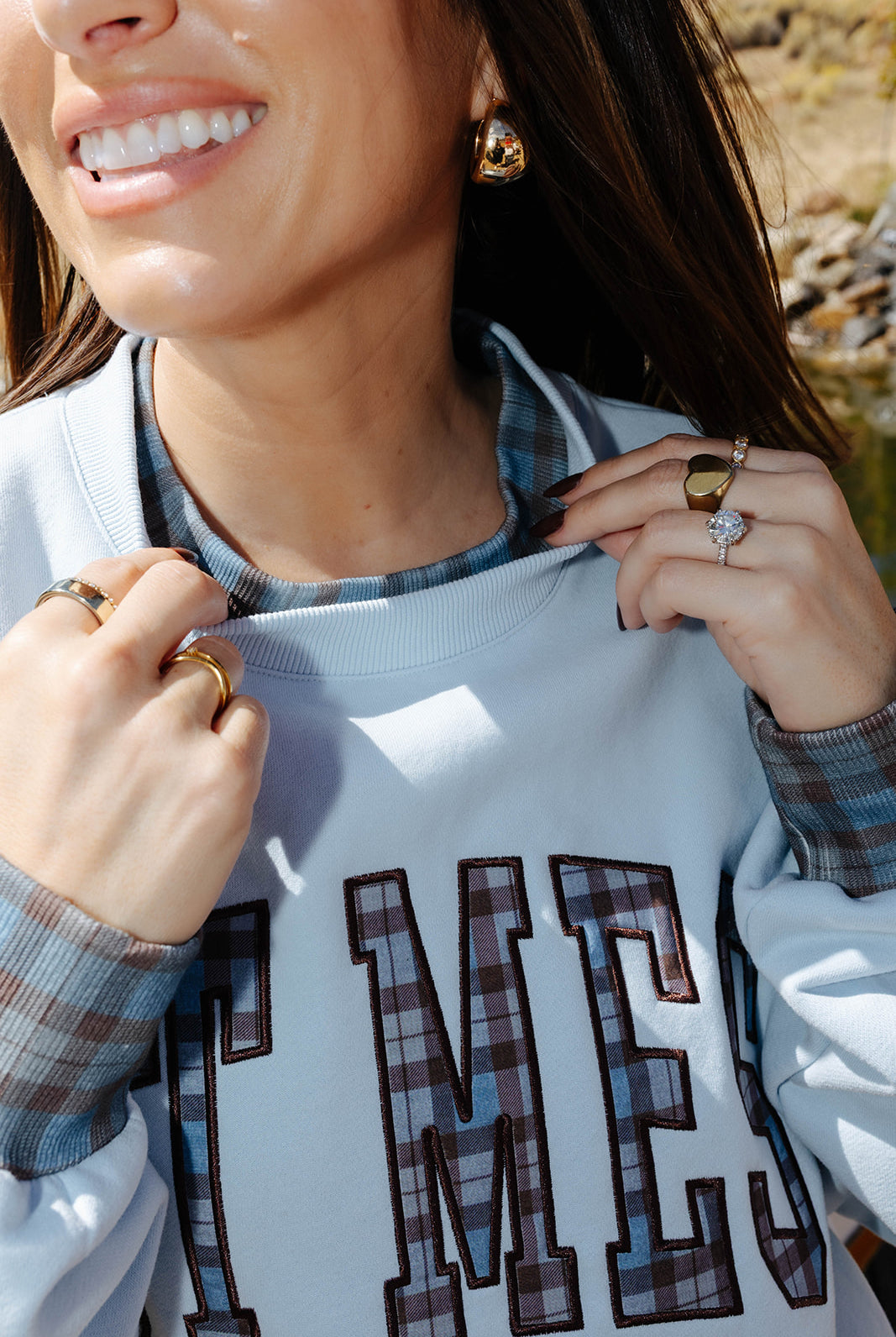 Close view of the Hot Mess sweatshirt neckline with plaid trim.