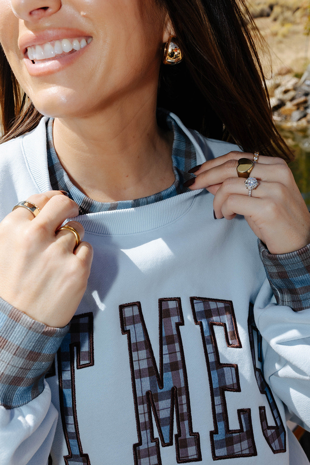 Close view of the Hot Mess sweatshirt neckline with plaid trim.