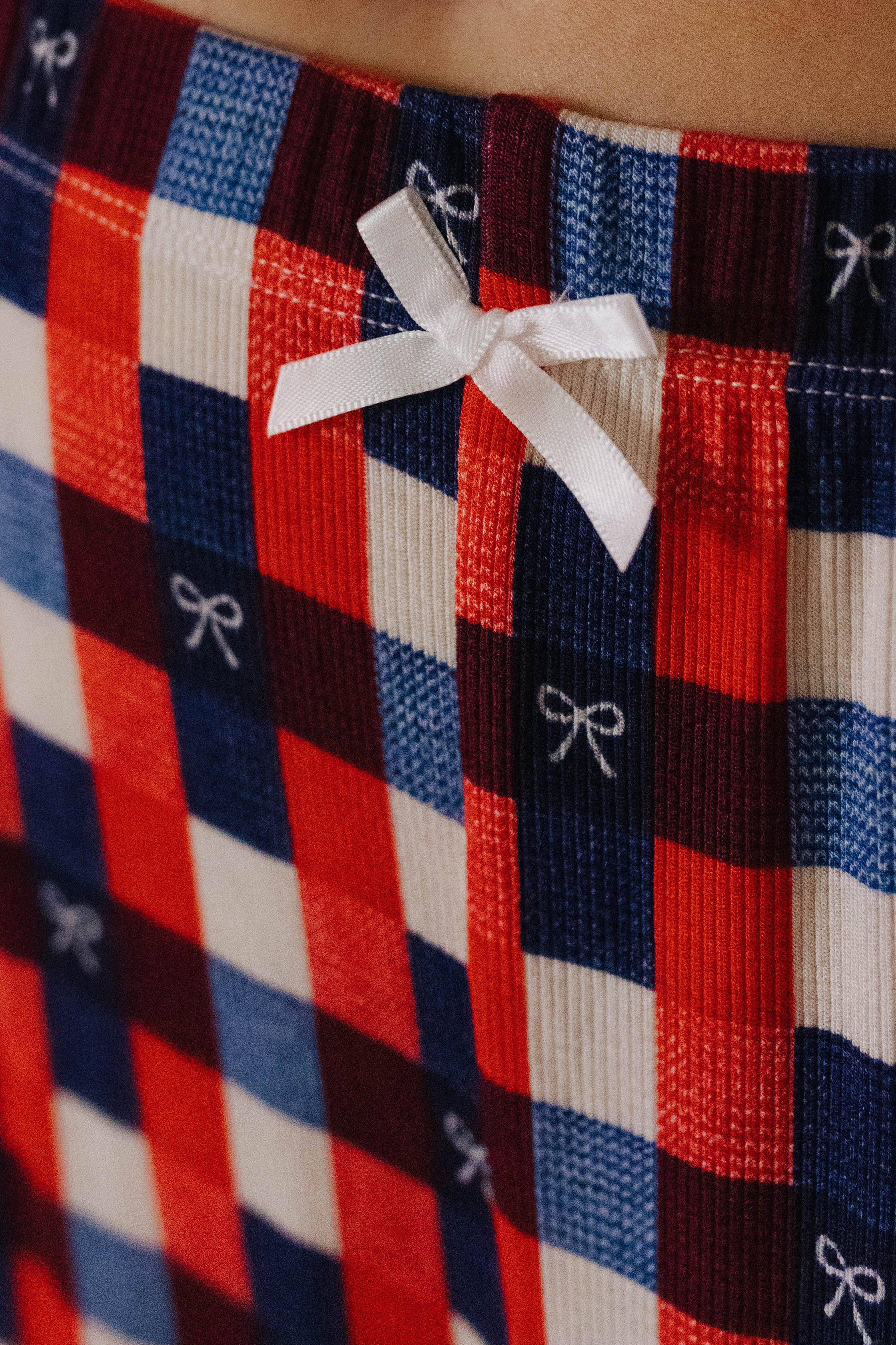 showing the white bow detail on the waistband