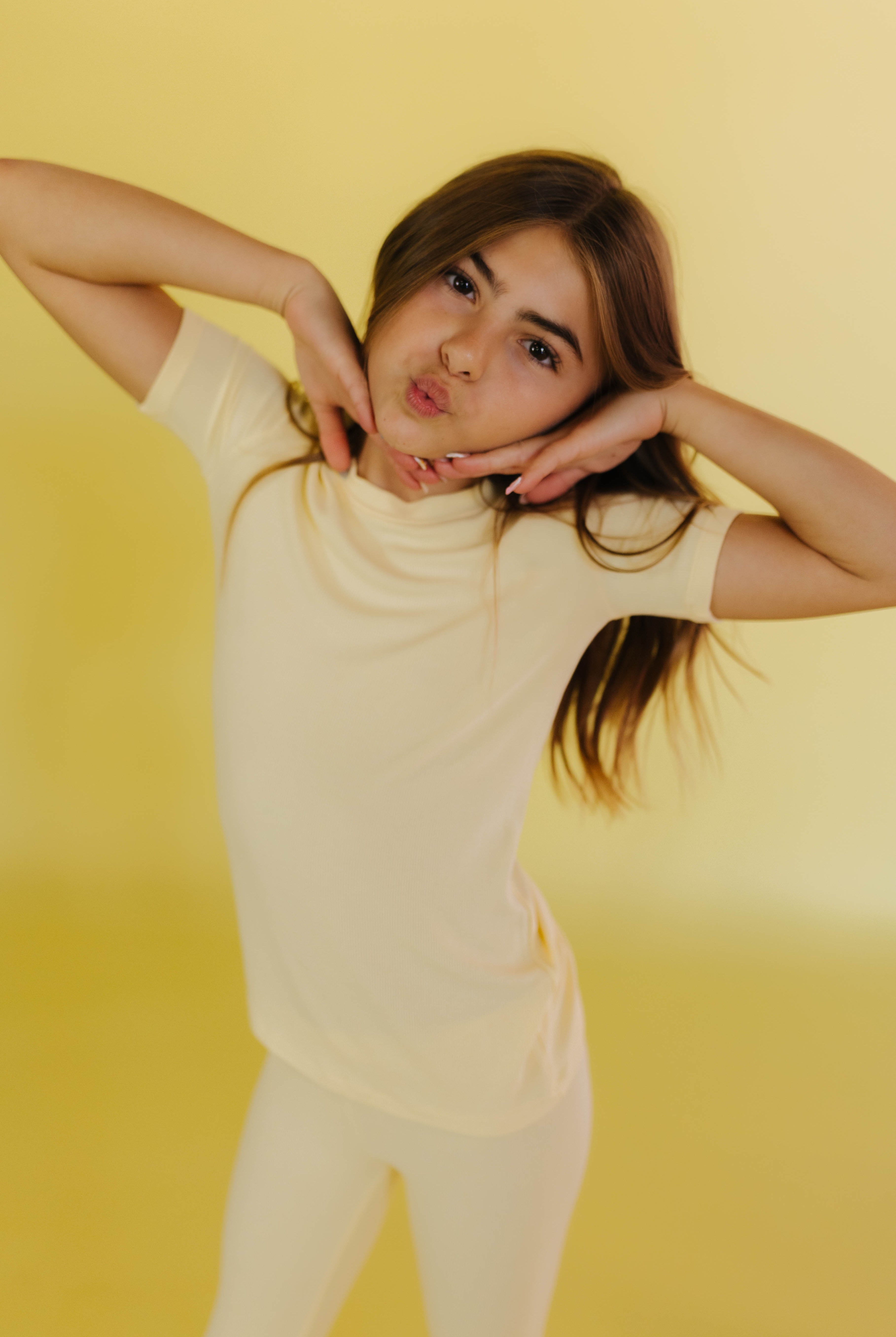 Kolly posing with a kissy face and hands under her face