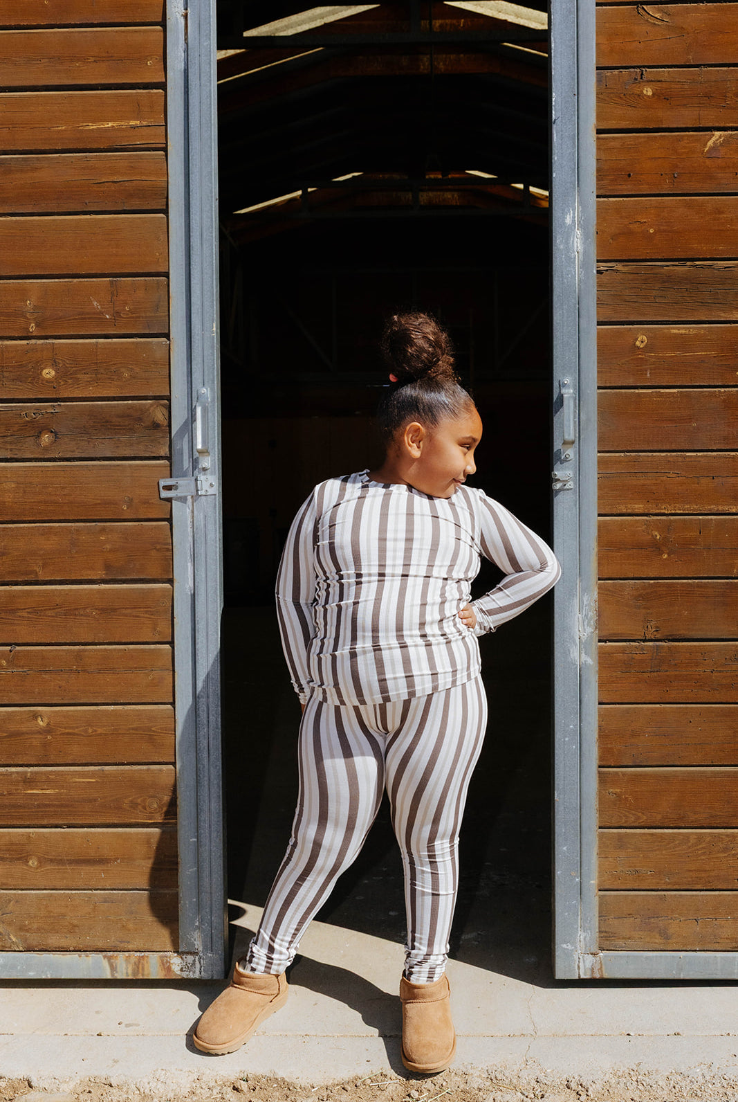 Back view of the kid brown stripe pajama top and pants.