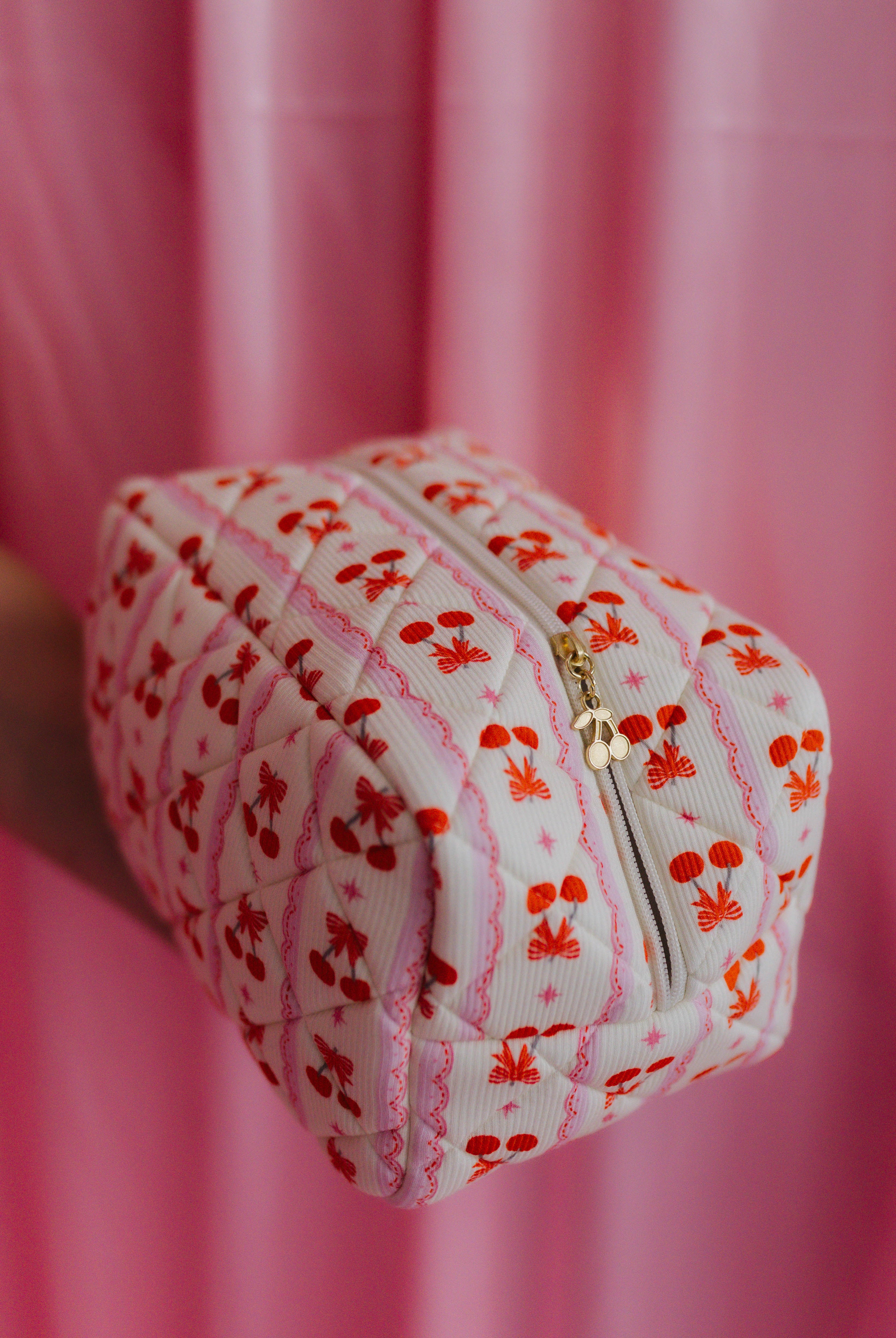 cosmetic bag showing the bow and cherry detail