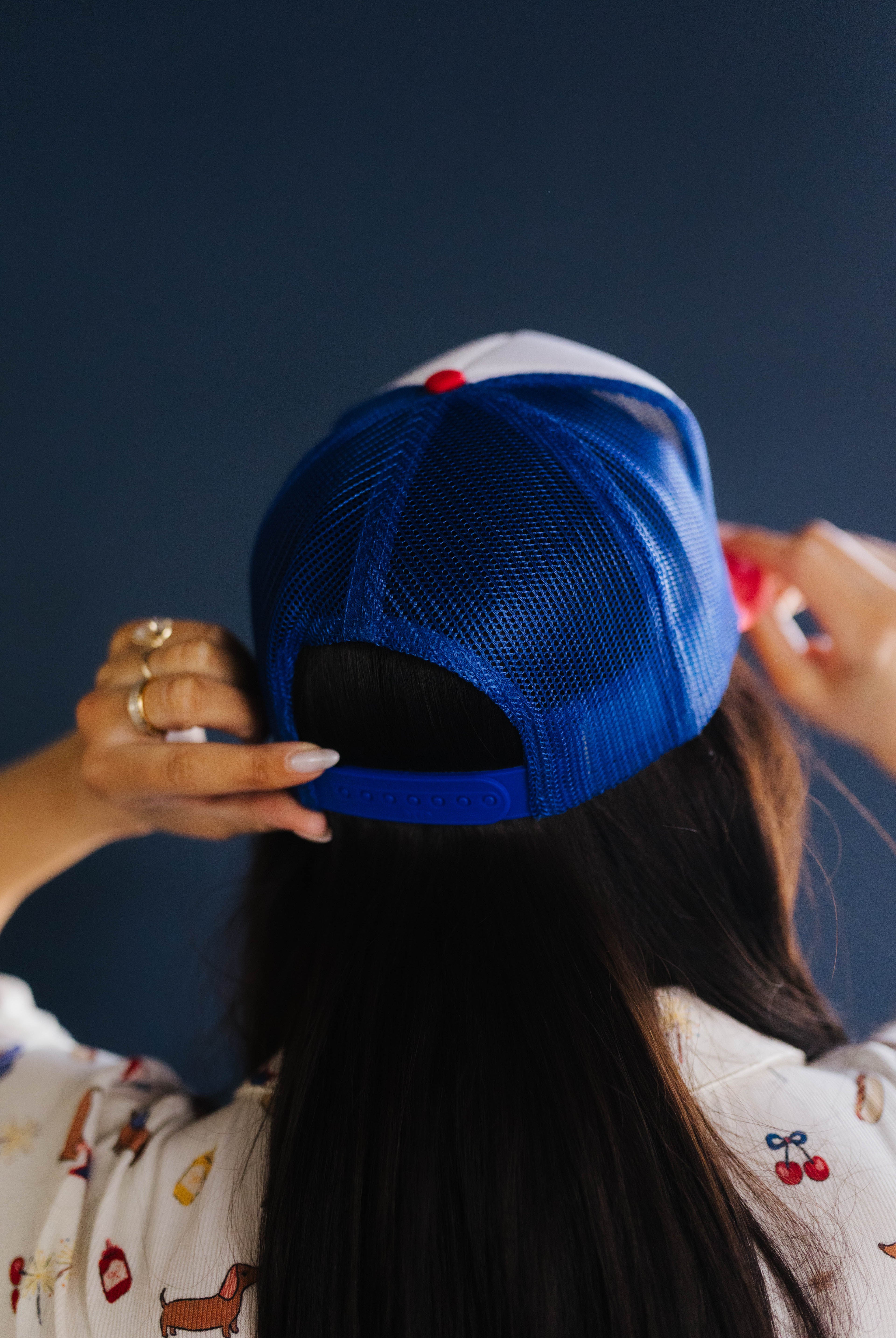 Person wearing a blue cap with a dark background