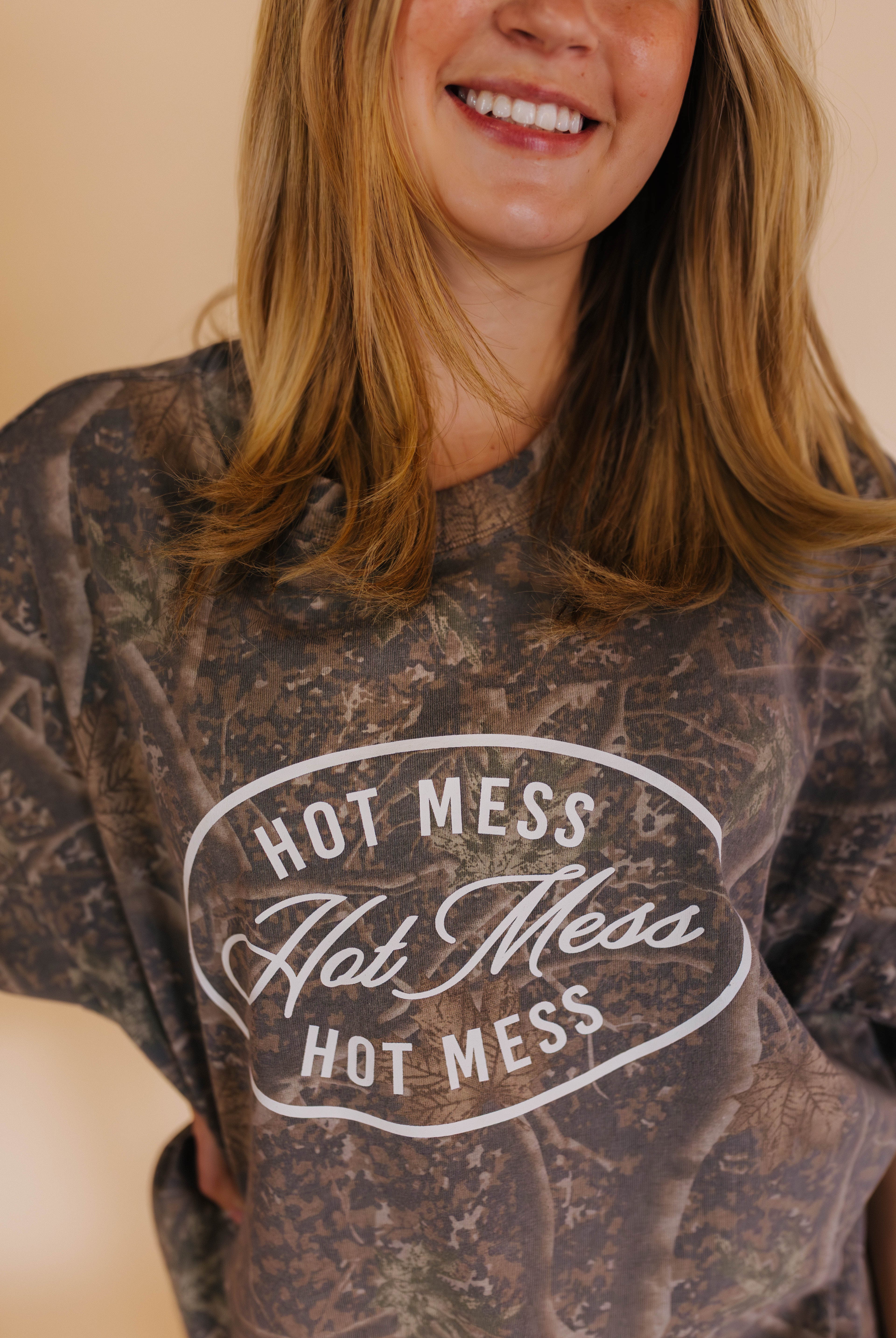 close up of hot mess tee detail with camo background