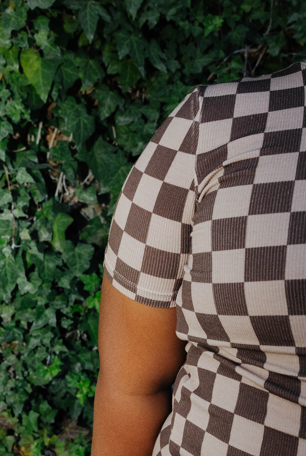 Close view of the brown check print on a kid pajama sleeve.