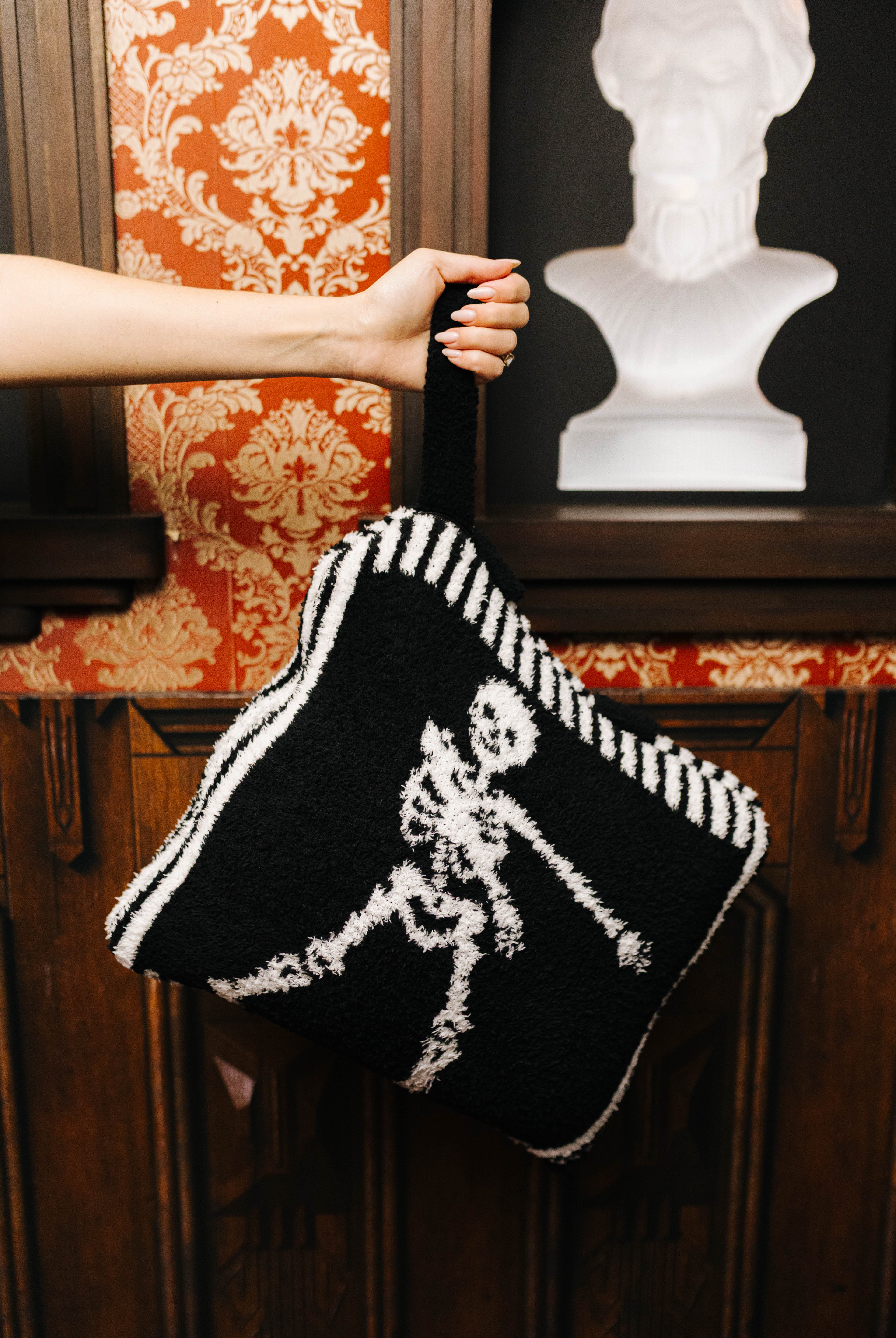 Skelly quillow carried by its wristlet strap
