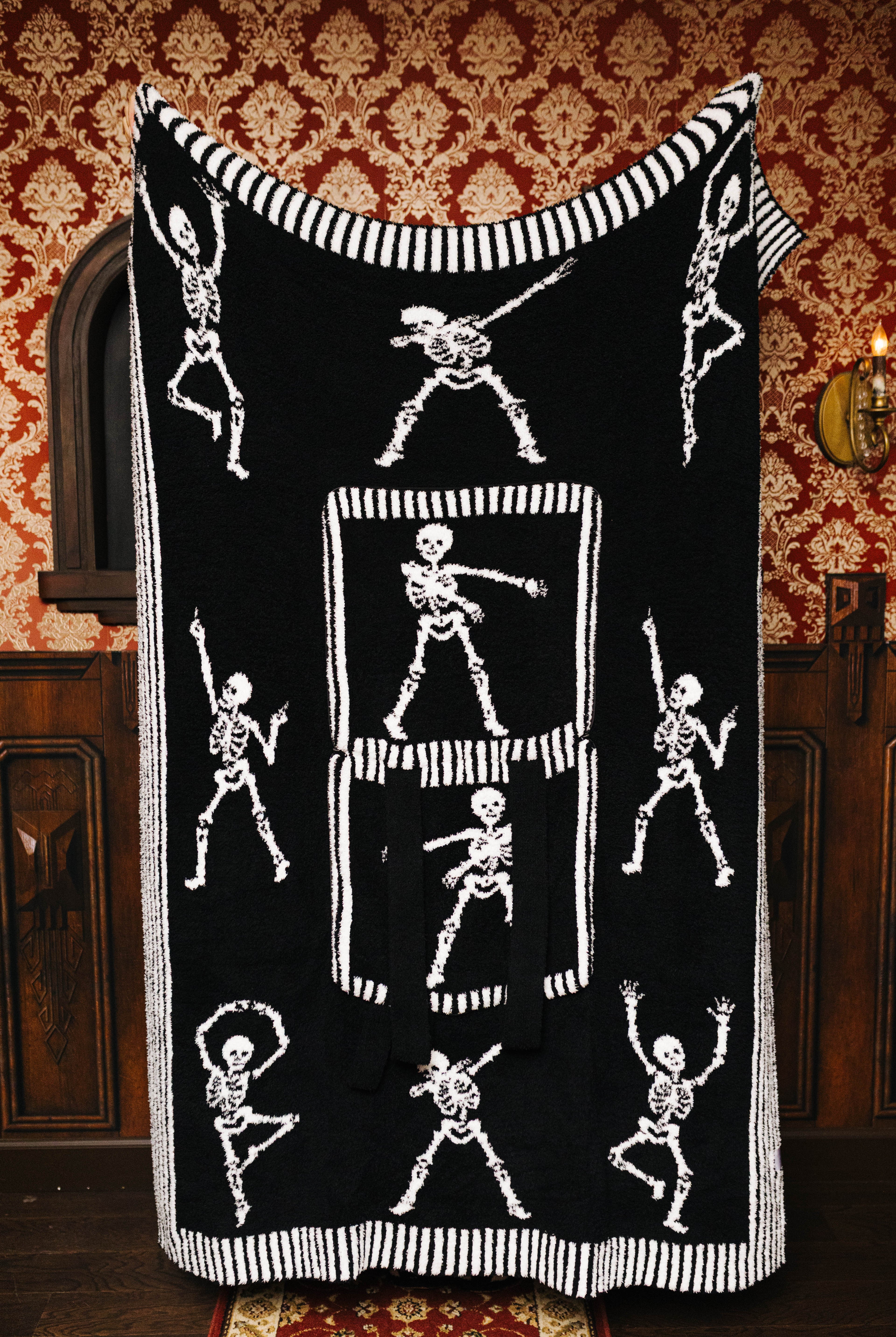 Skelly quillow unfolded to show the black skeleton side