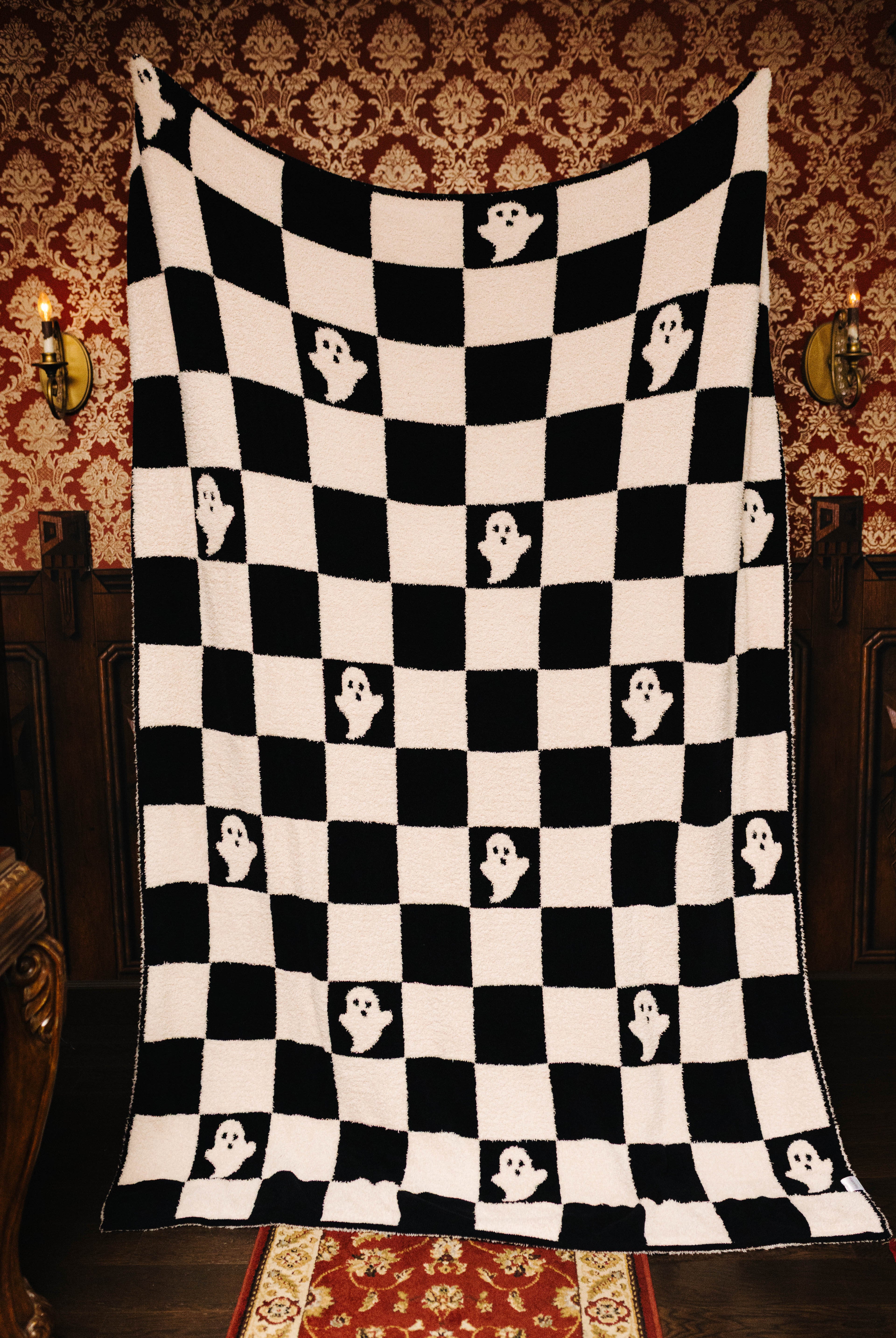 Ghost Check blanket held open to show the full pattern